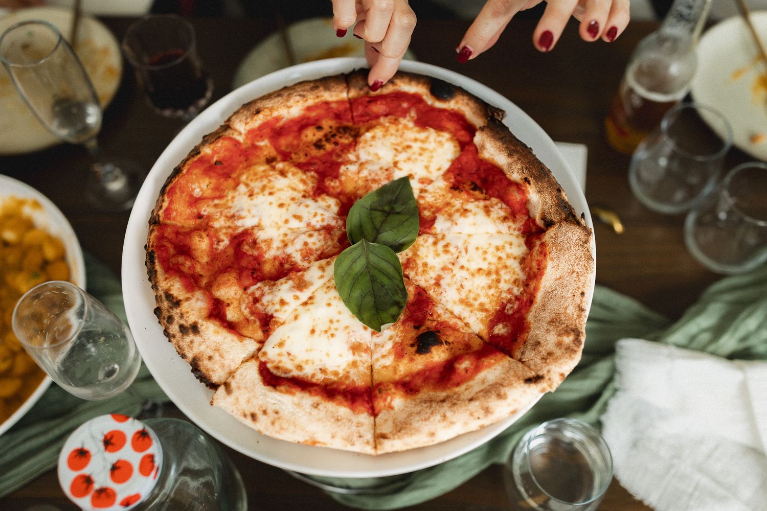 A classic Margherita pizza with fresh basil and mozzarella served at a wedding reception dinner.