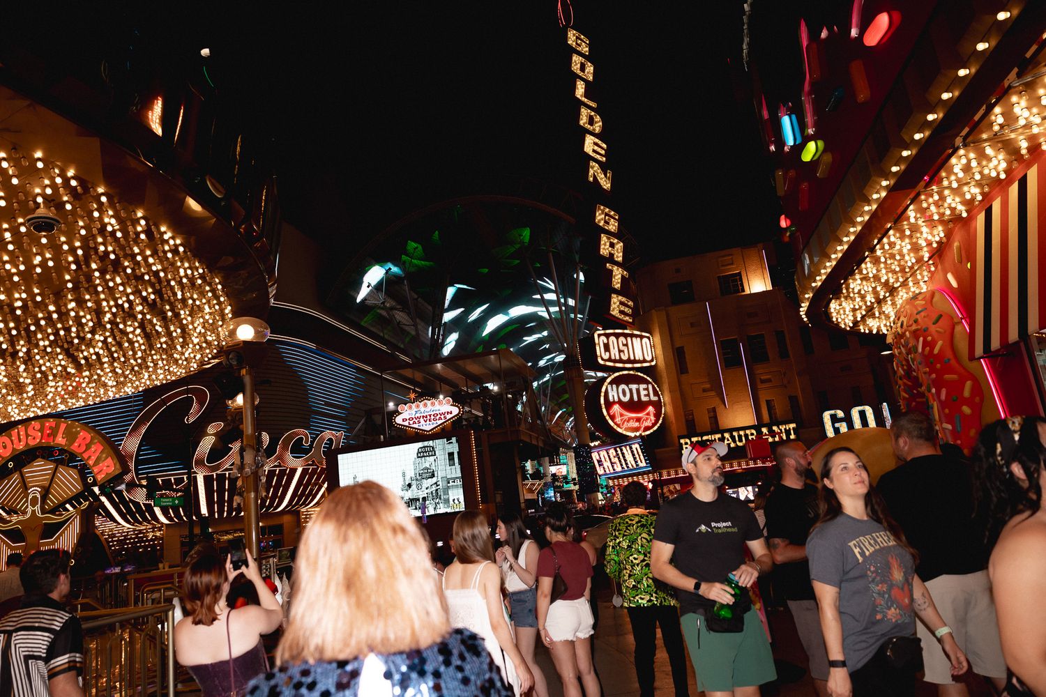 Crowds of people celebrate at night outside the Golden Gate Casino on Fremont Street in Las Vegas.