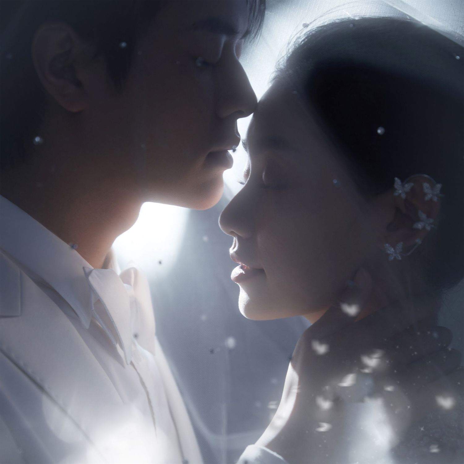 Asian couple in close romantic pose with soft glowing light and floral bokeh wedding photo.