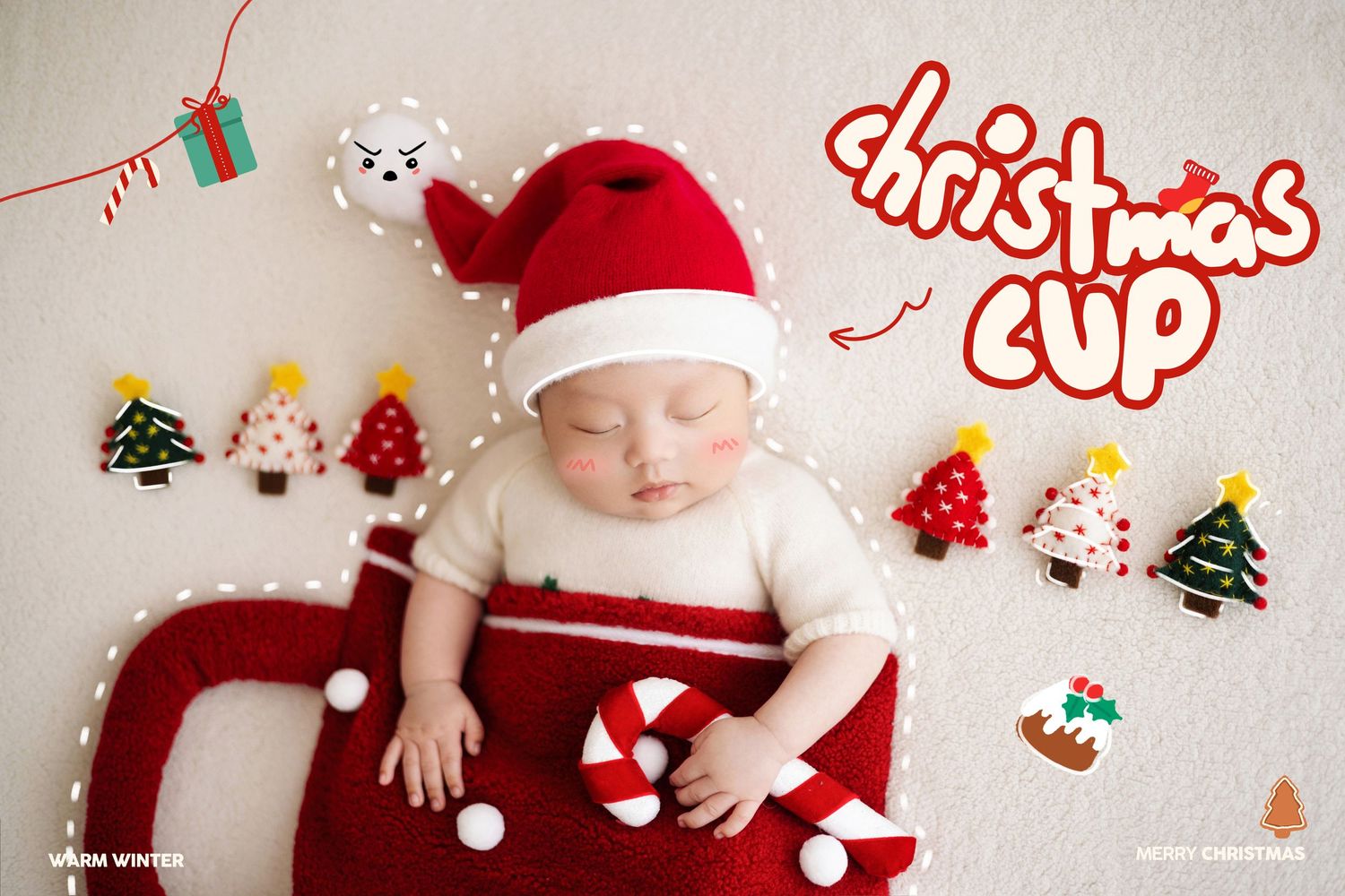 Newborn in Santa hat resting in red Christmas cup surrounded by festive tree decorations and candy cane.