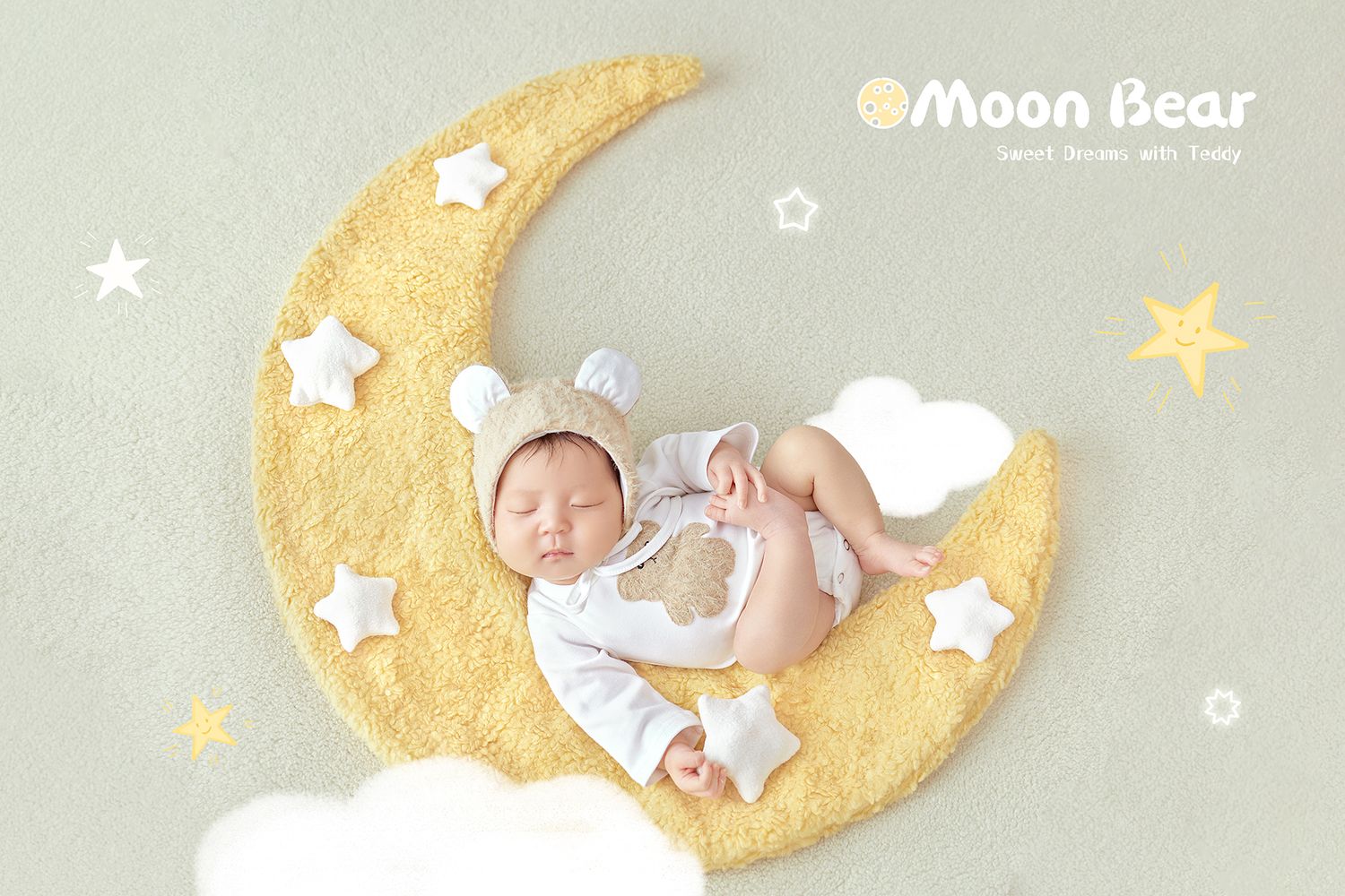 Newborn baby in bear bonnet sleeping on yellow crescent moon prop with stars and clouds.