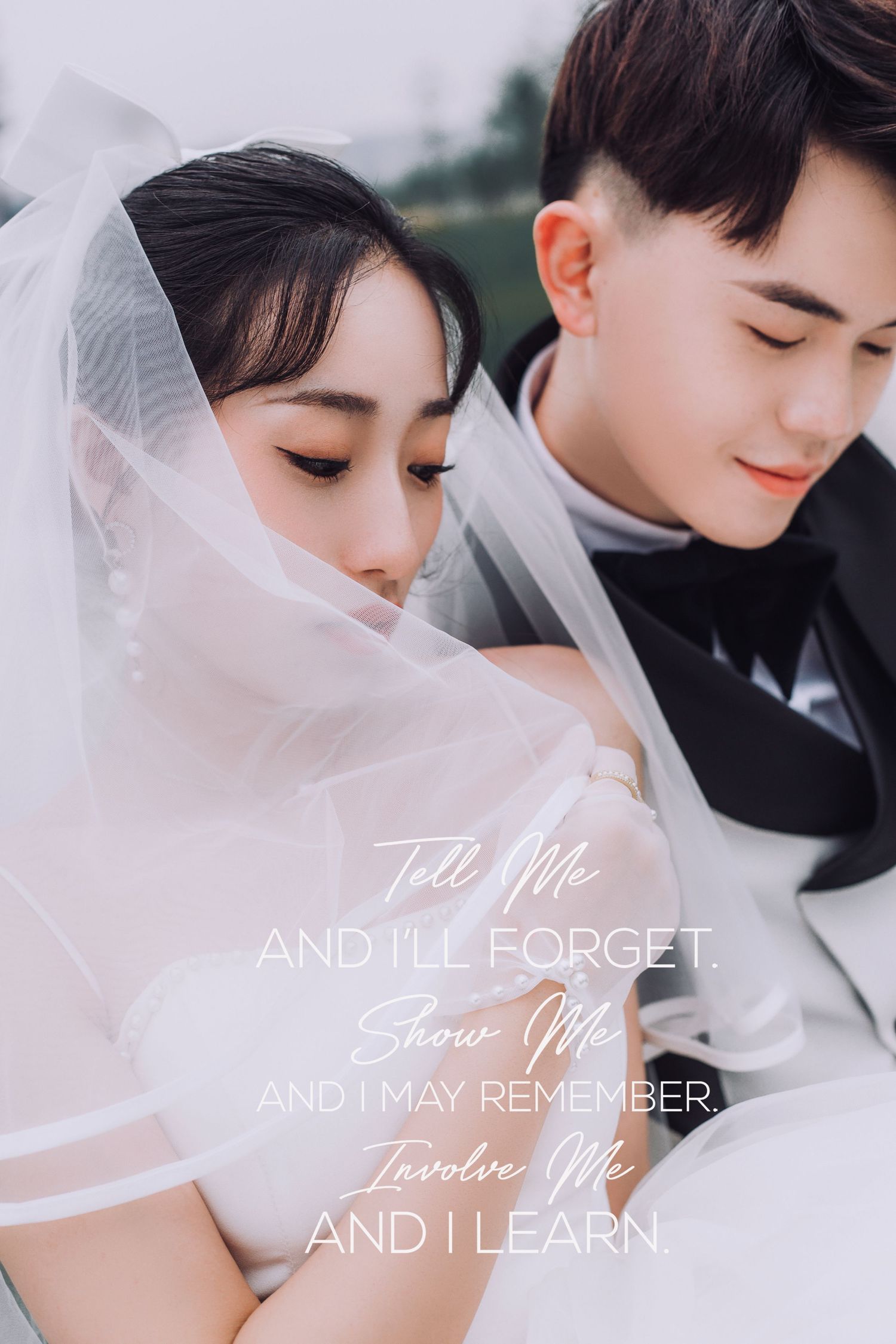Romantic bride and groom share tender moment under sheer veil with inspirational quote overlay.