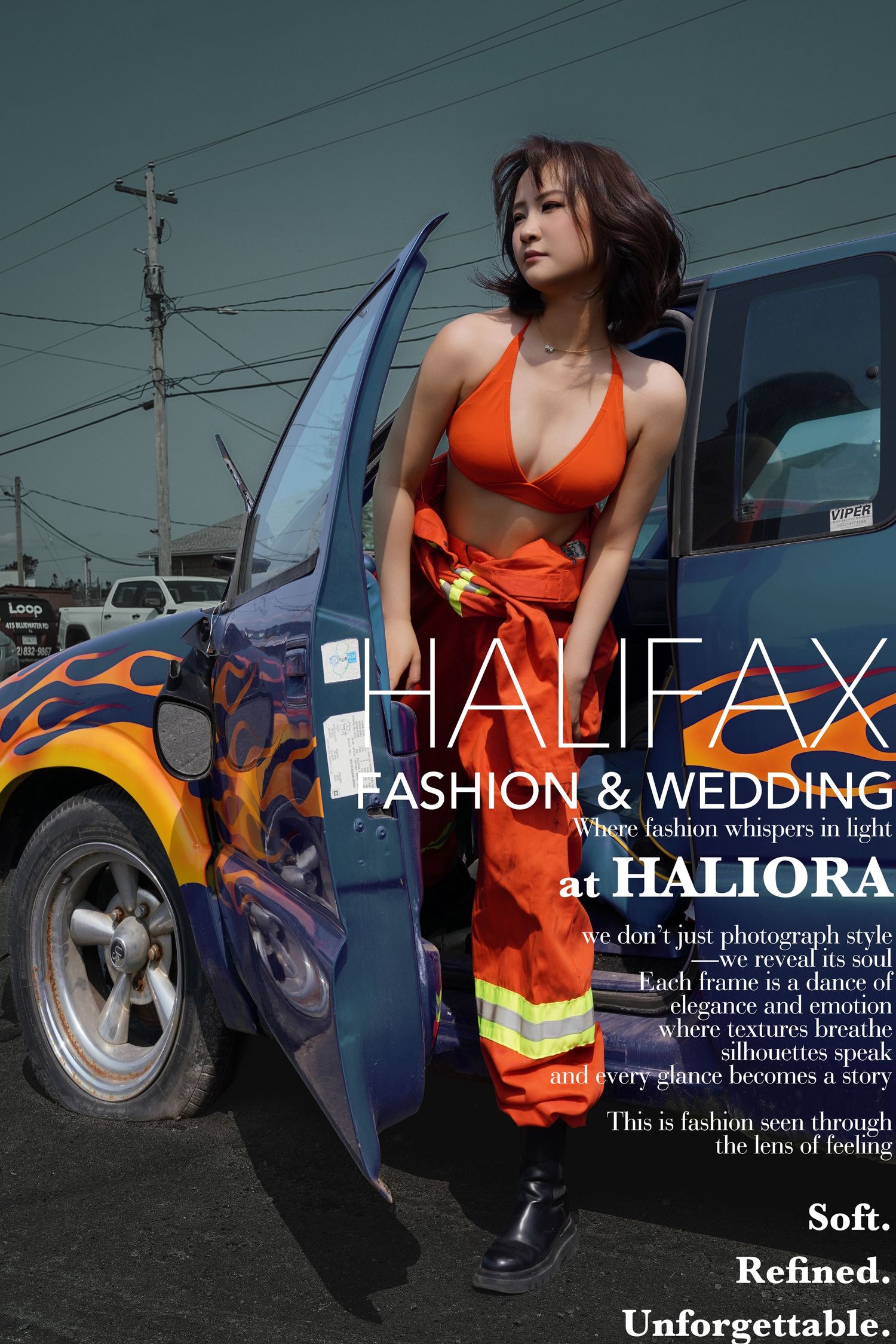 Model in red bikini top and open firefighter overalls poses beside a flame-painted truck for Halifax Fashion & Wedding.