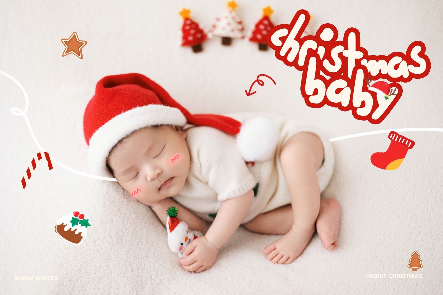 Newborn wearing Santa hat sleeping on white blanket surrounded by Christmas-themed decorative icons and toys.