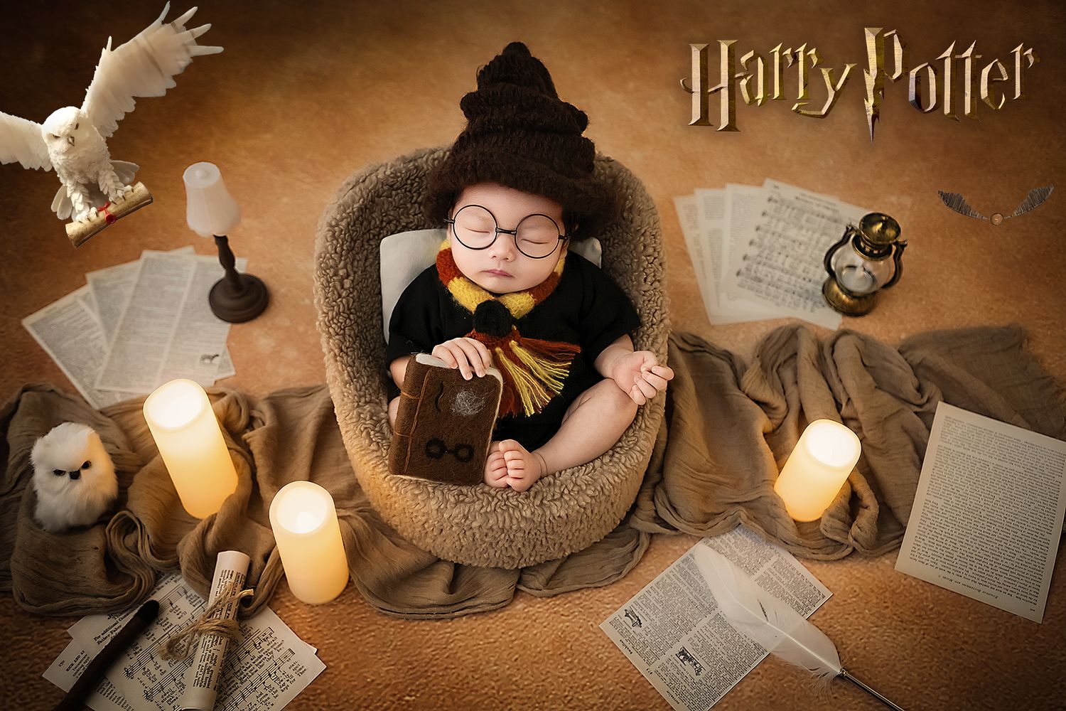 Newborn baby in Harry Potter costume with glasses, holding book, surrounded by candles and owl in magical setup.