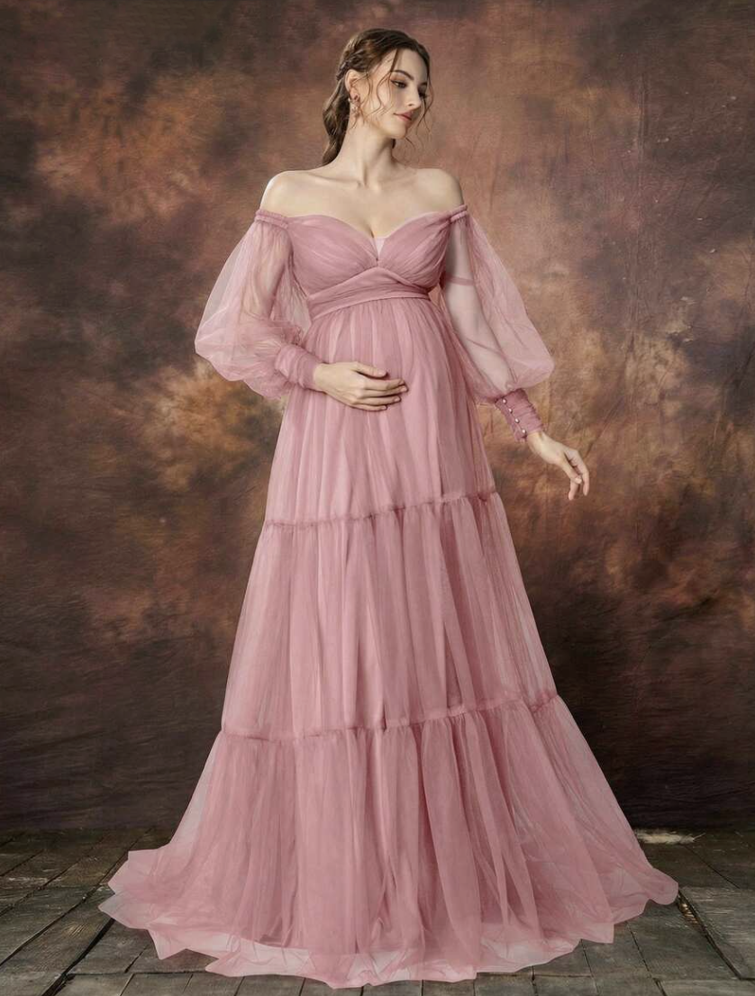 Elegant dusty rose maternity gown with off-shoulder neckline, sheer puff sleeves, and tiered tulle skirt.