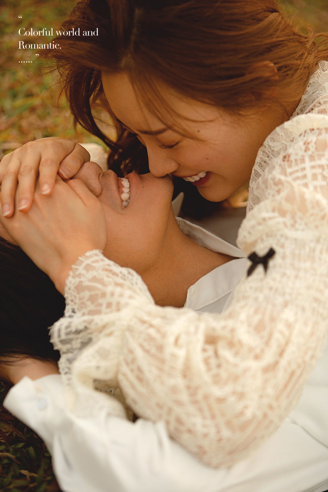 Couple sharing a romantic moment lying in autumn leaves.