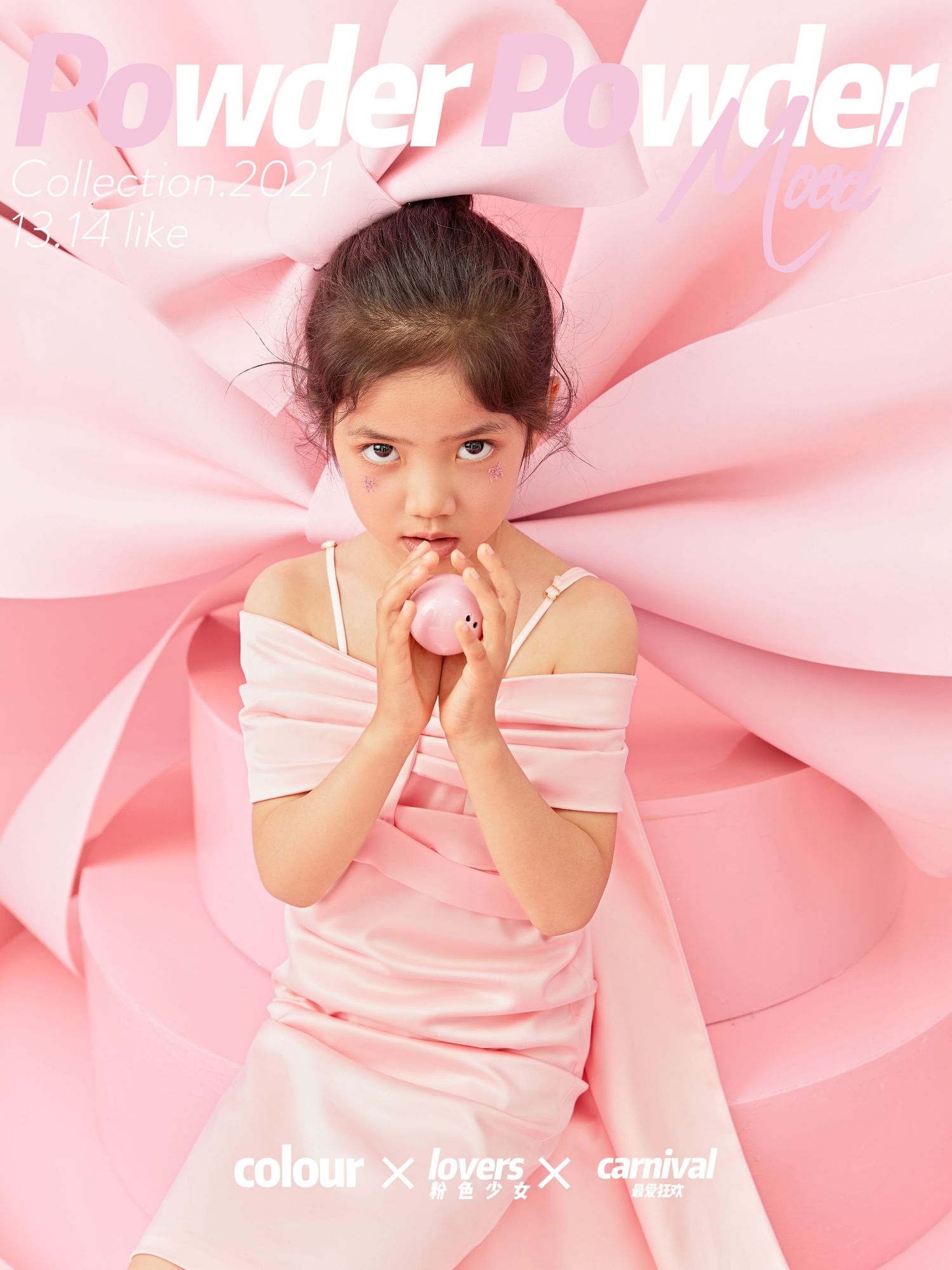 Young girl in pink off-shoulder dress poses against oversized pink bow backdrop.