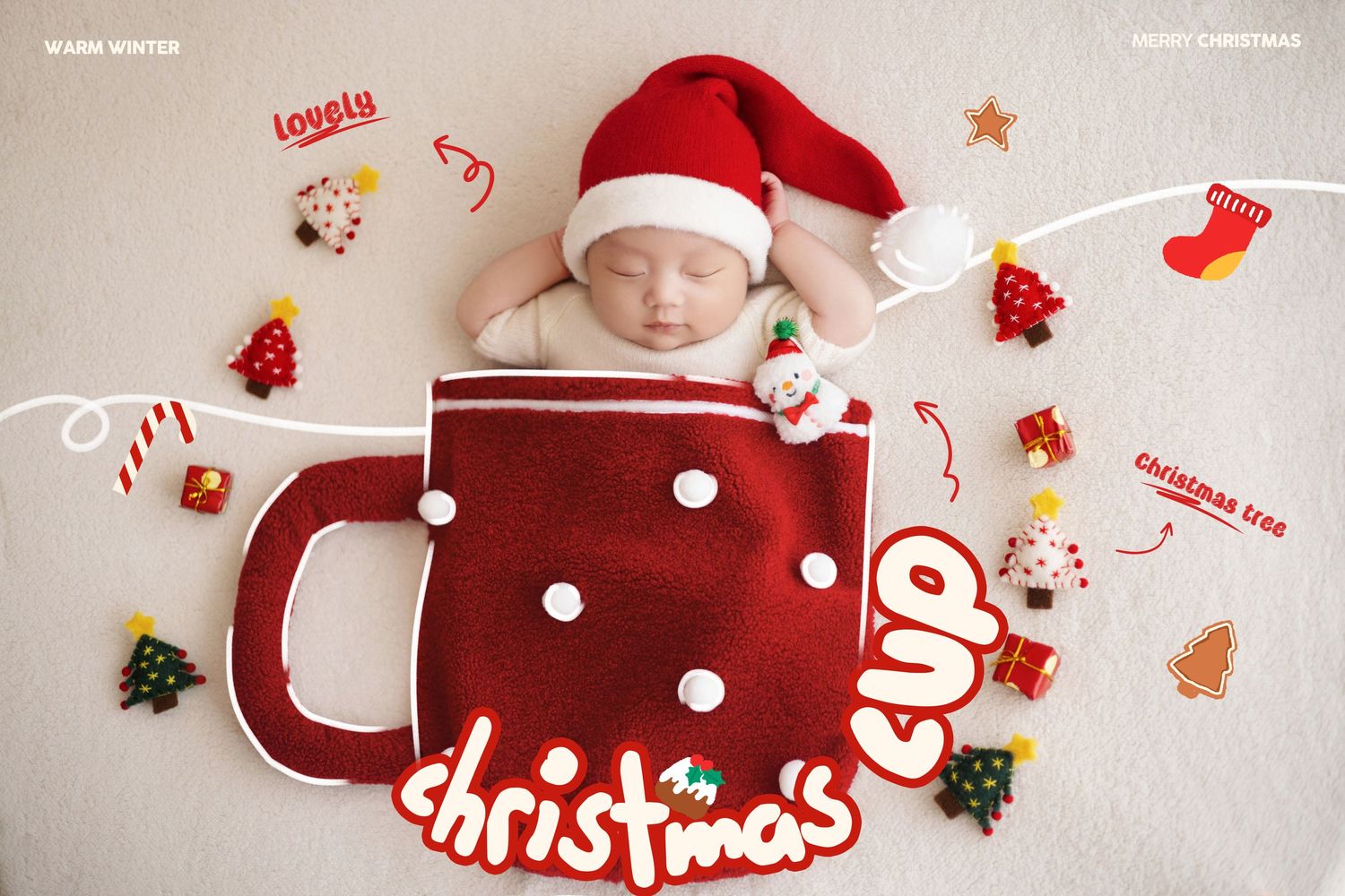 Newborn baby sleeping in red knit Christmas mug prop with Santa hat and holiday ornaments on white background.