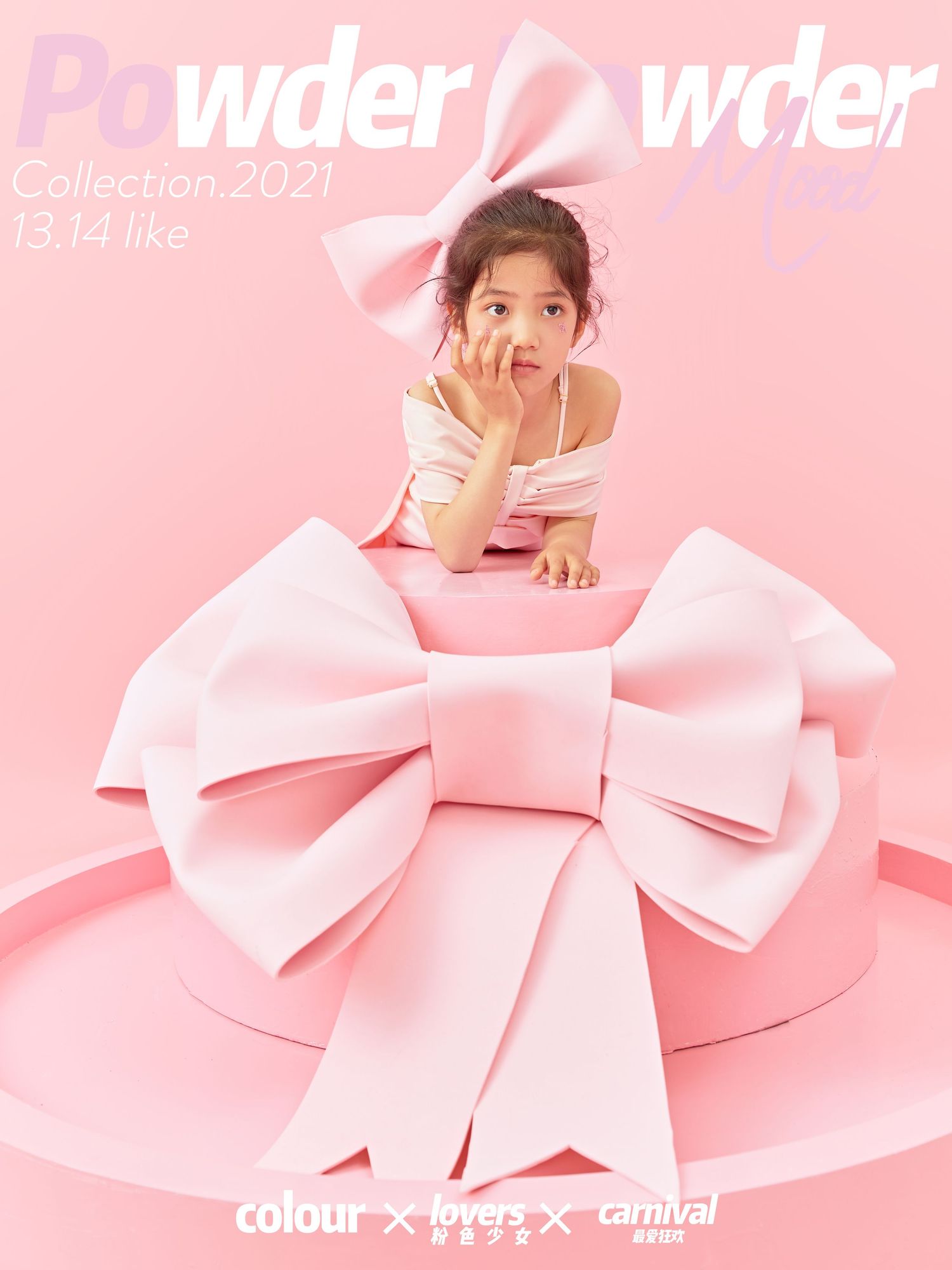 Young girl in pink outfit poses inside large decorative pink bow on pink background.