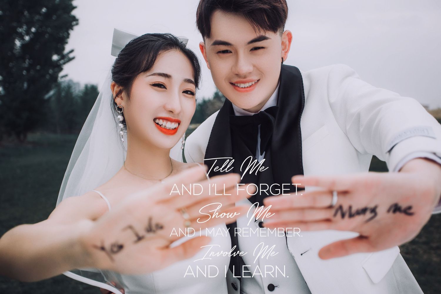 Laughing bride and groom take fun selfie outdoors with motivational quote text overlay visible.