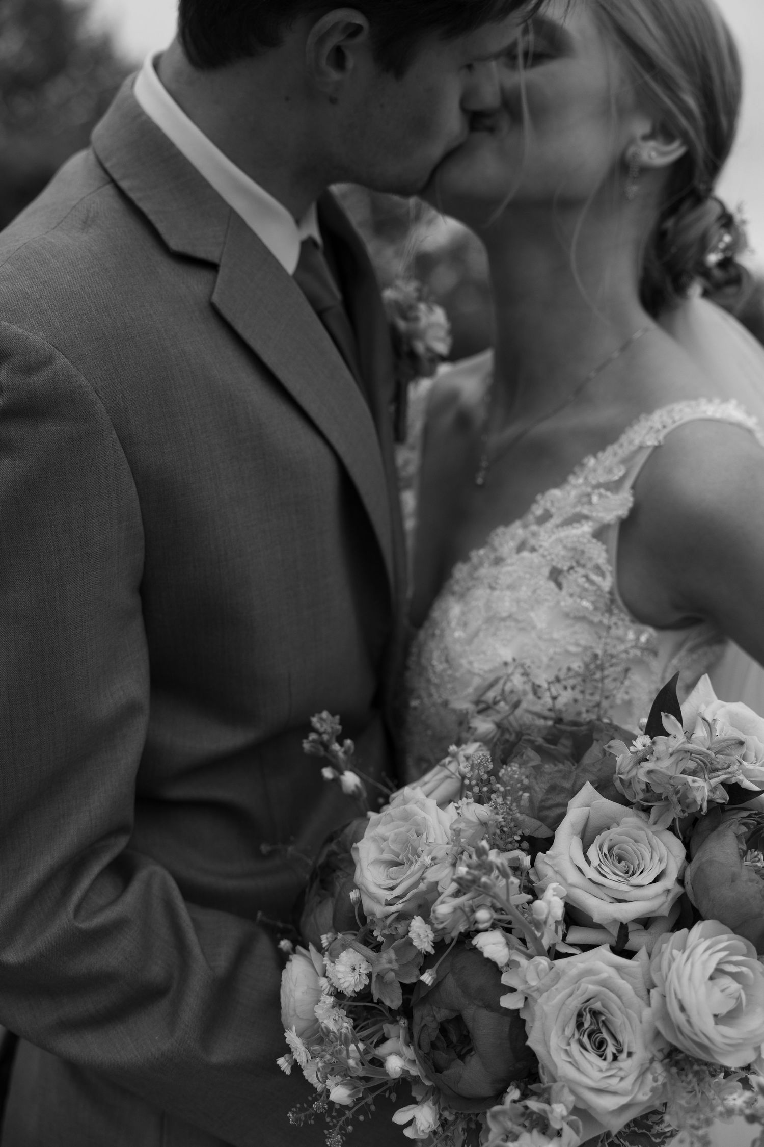 Black and white wedding photo featuring roses and intimate moments.