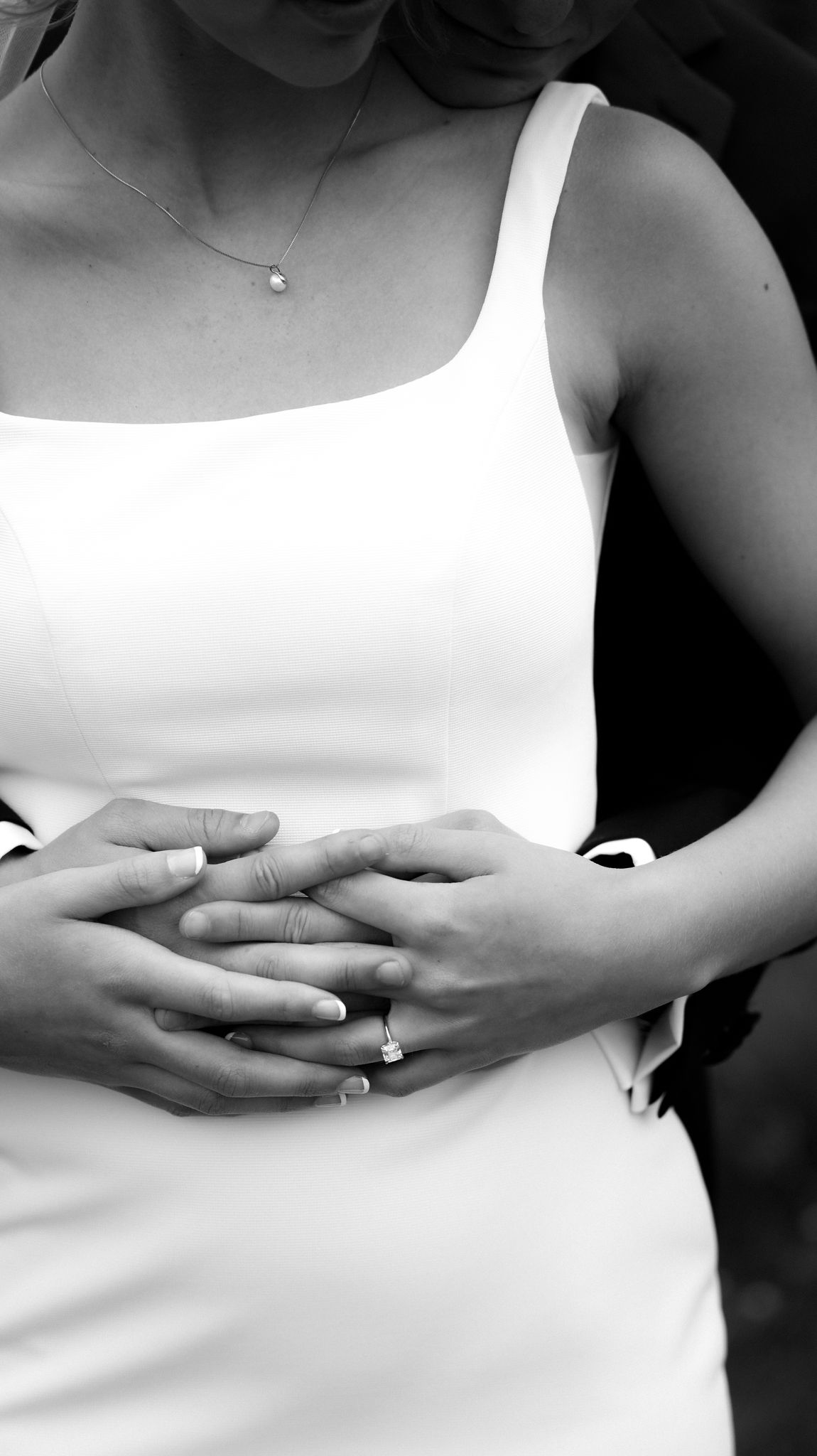 Close-up series of hands and white dress details in black and white.