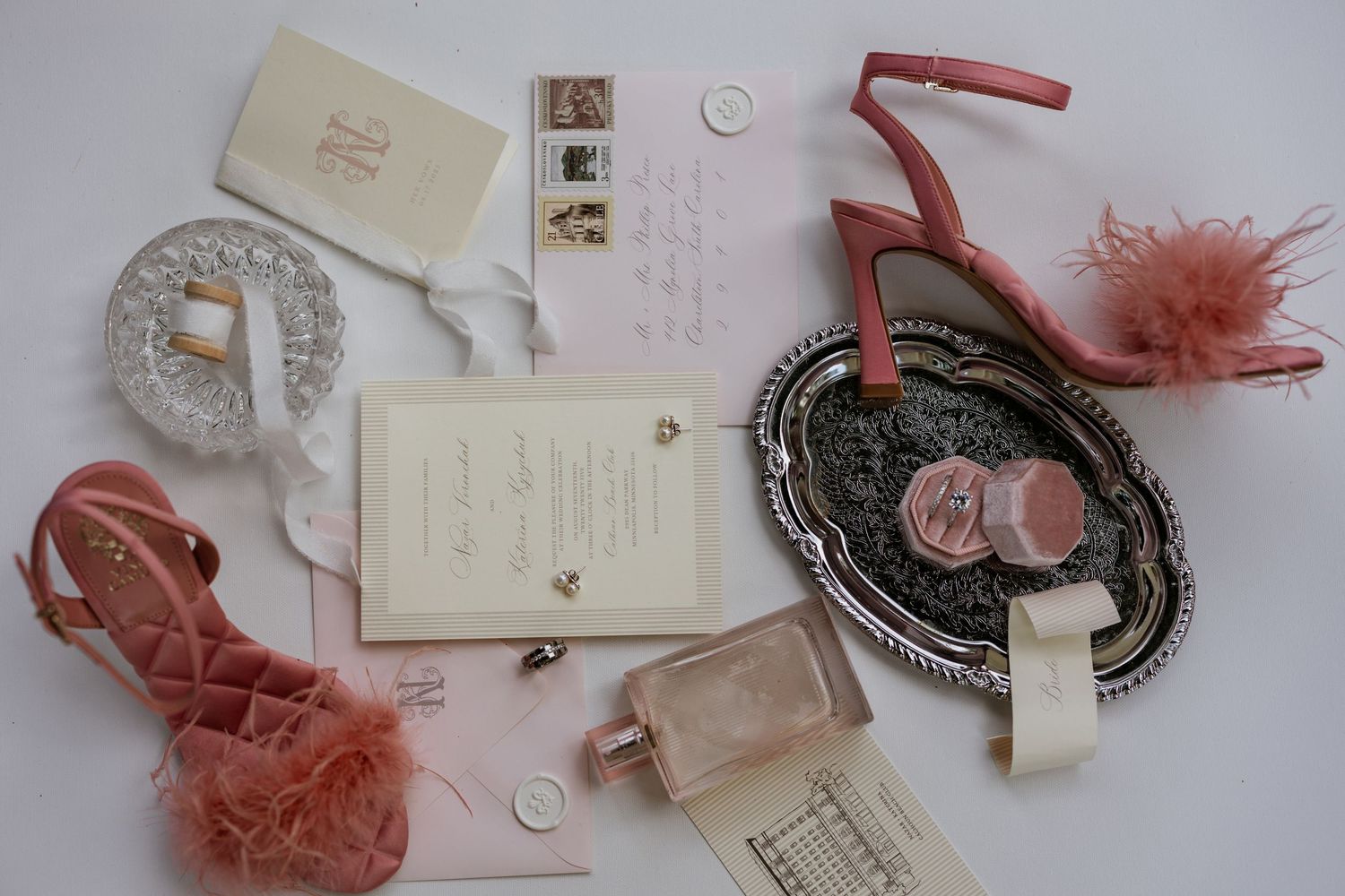 Collection of vintage-style wedding accessories in soft pink and neutral tones.