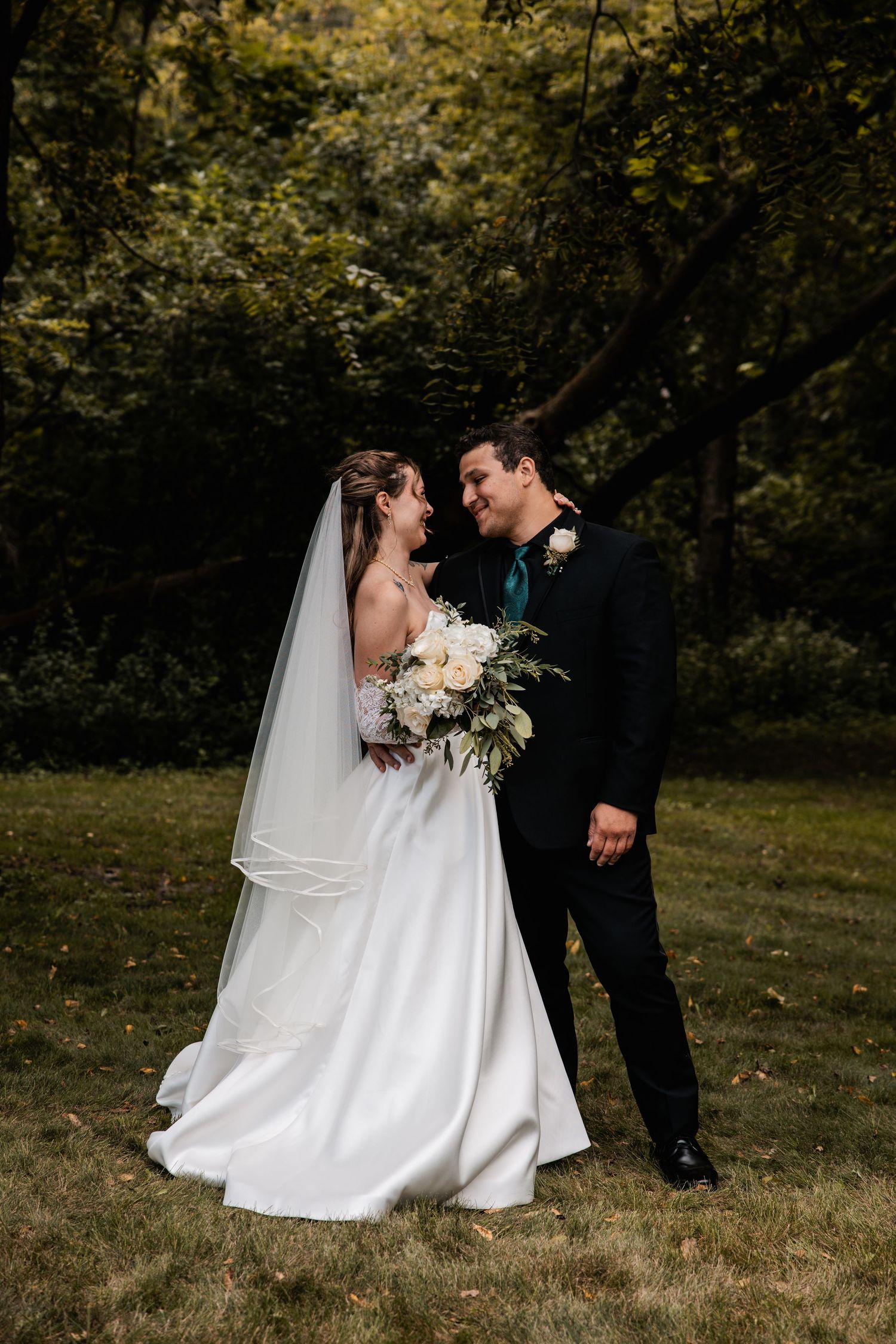 Candid wedding photography sequence showing tender moments between newlyweds in a forest.