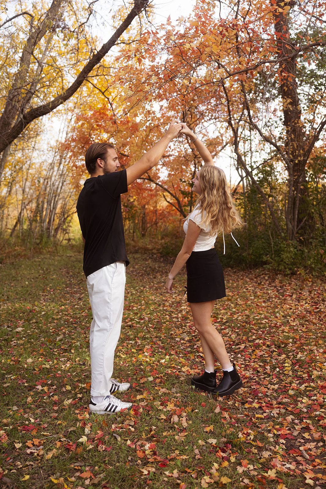 Sequence showing couple performing dance lift in fall forest setting.