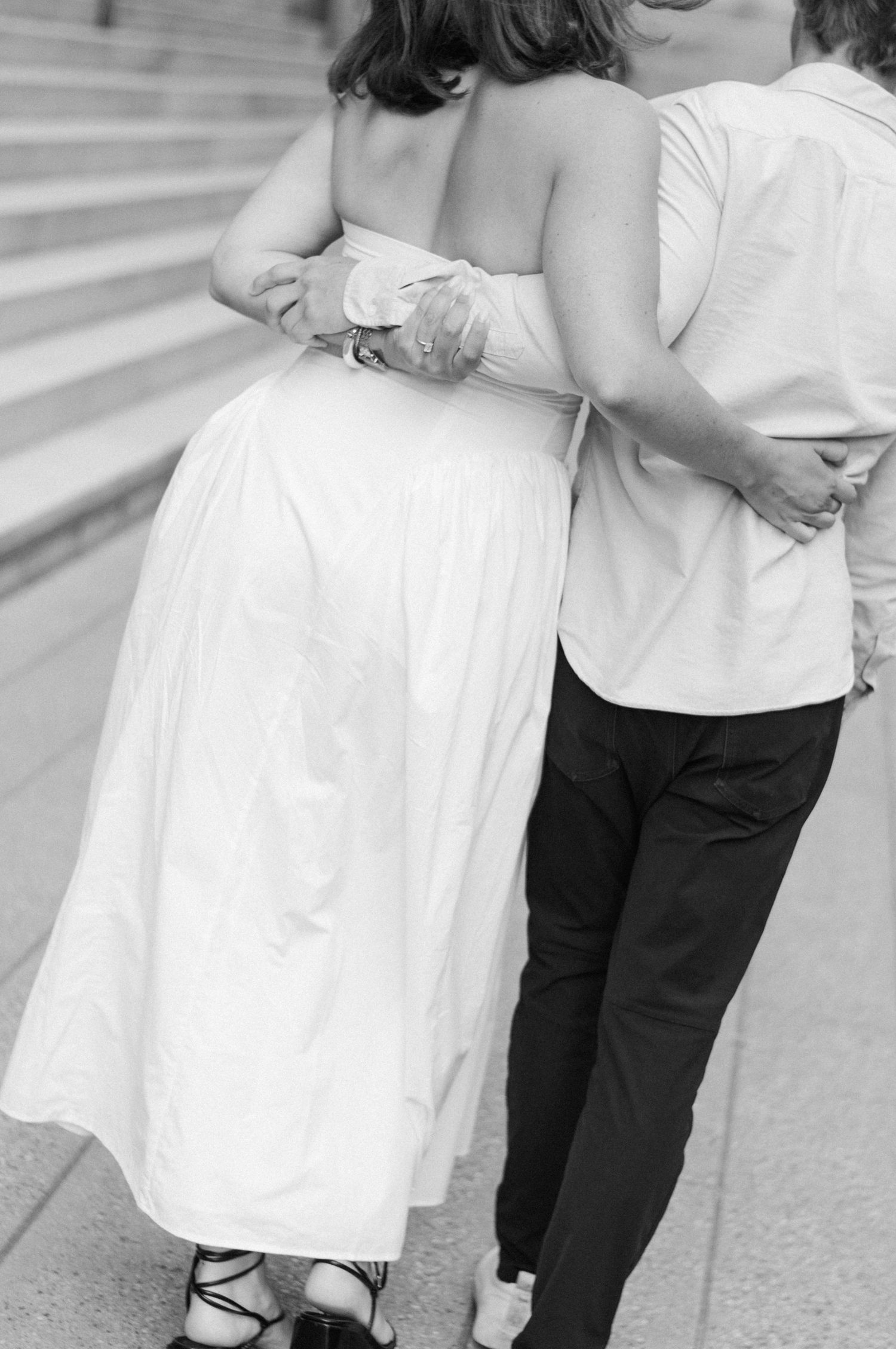 Couple holding each other while walking in engagement shoot in Chicago