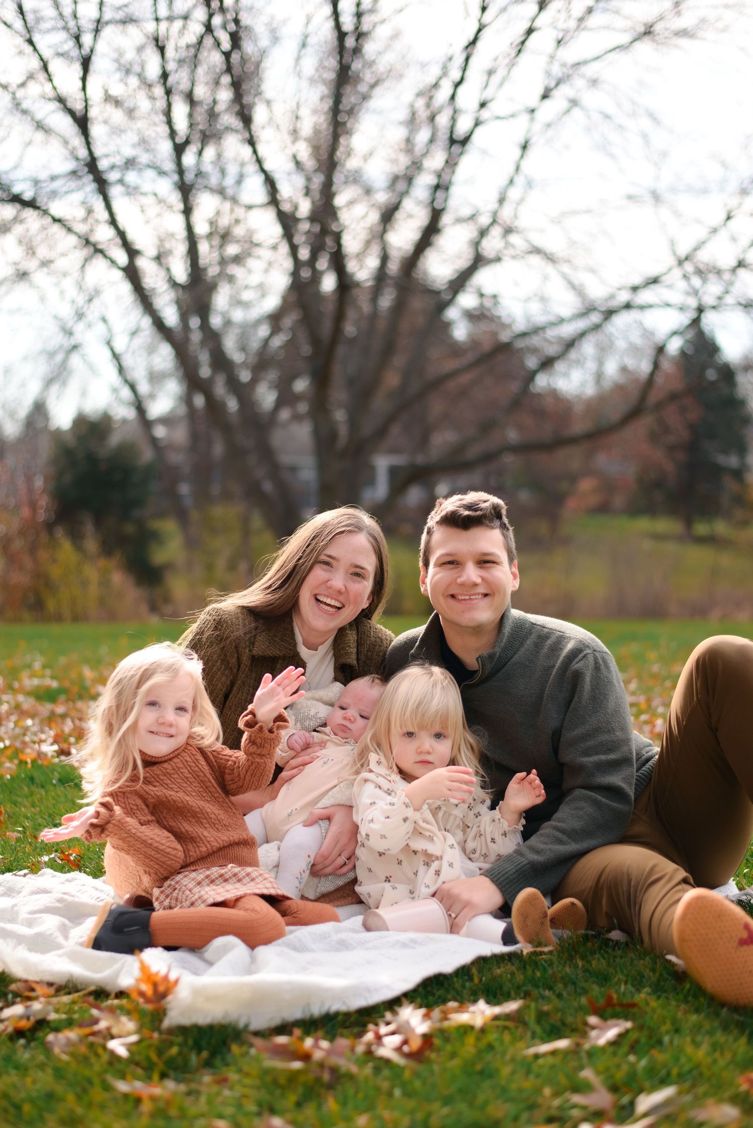 Family smiling for camera during intimate fall shoot