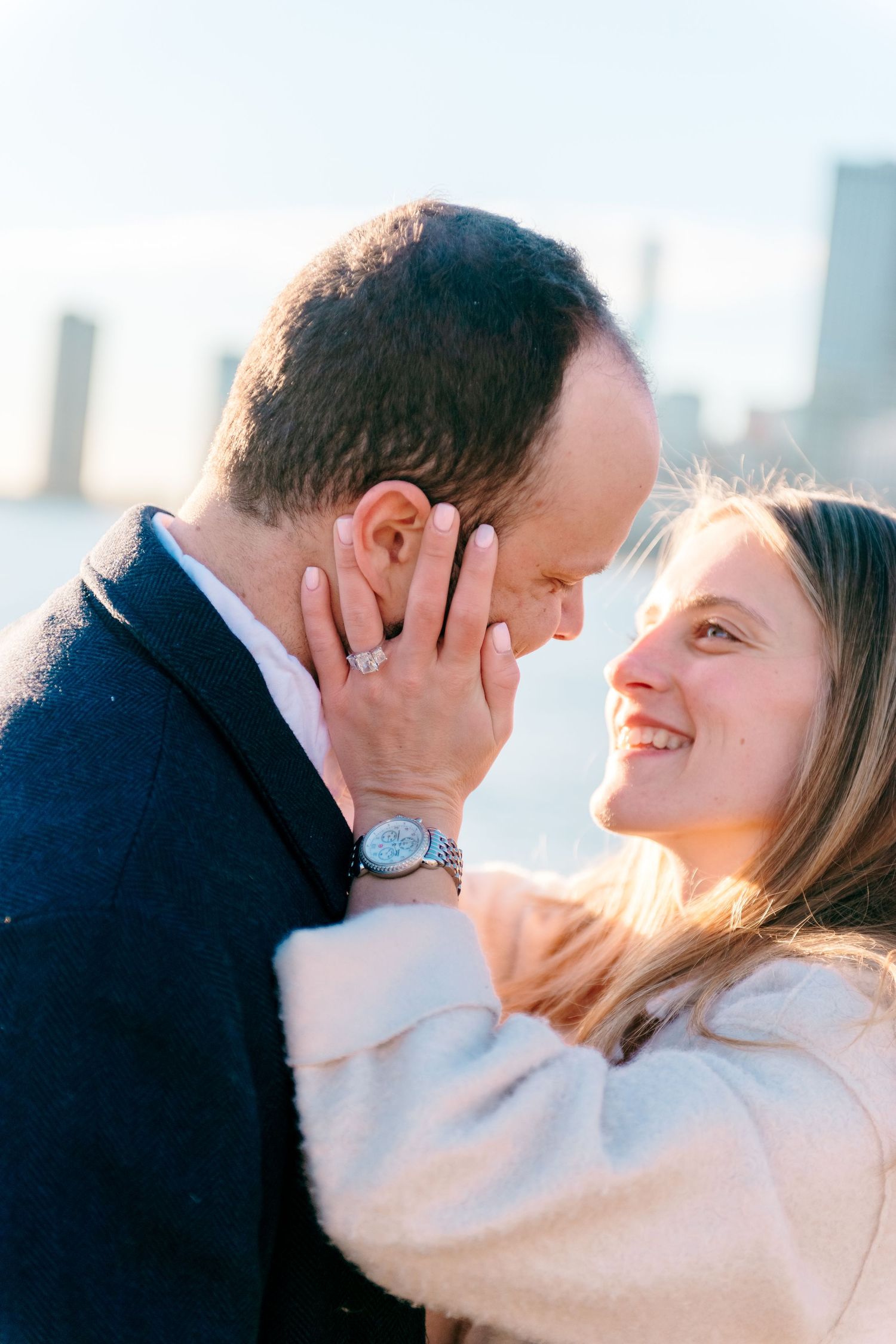 Engaged couple holding each other lovingly on the Chicago lakefront
