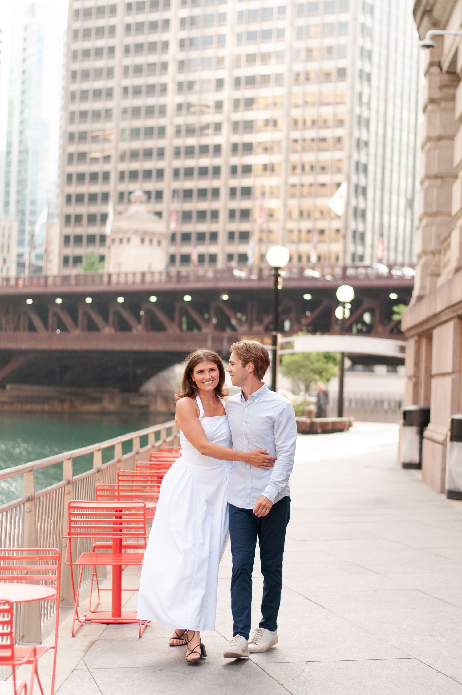 Engaged couple walking together during downtown engagement photo session