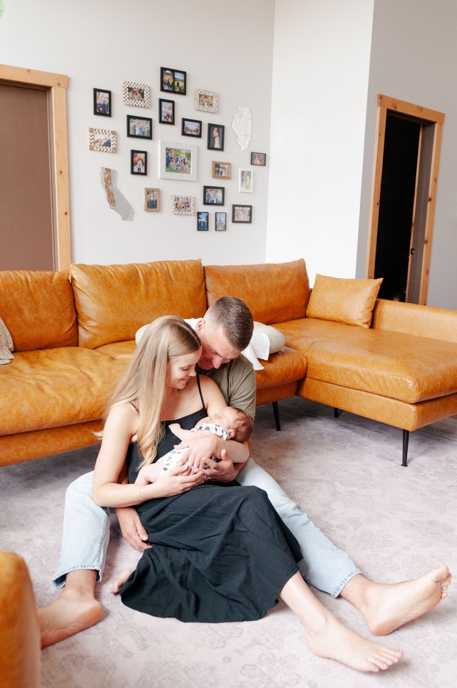Mother and father cradling newborn during quiet lifestyle portrait session