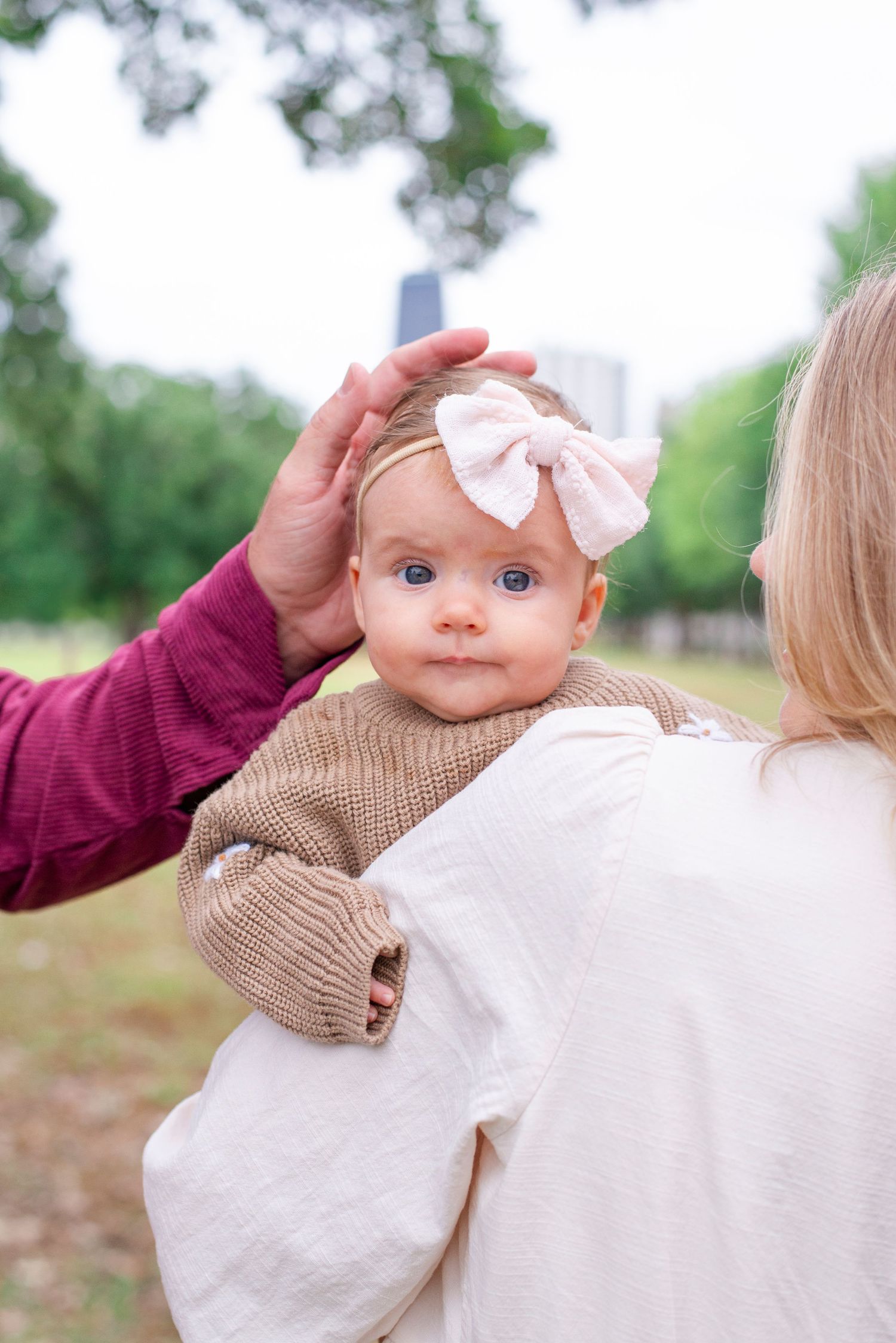 father cradling head of toddler during fall family portrait session in Chicago