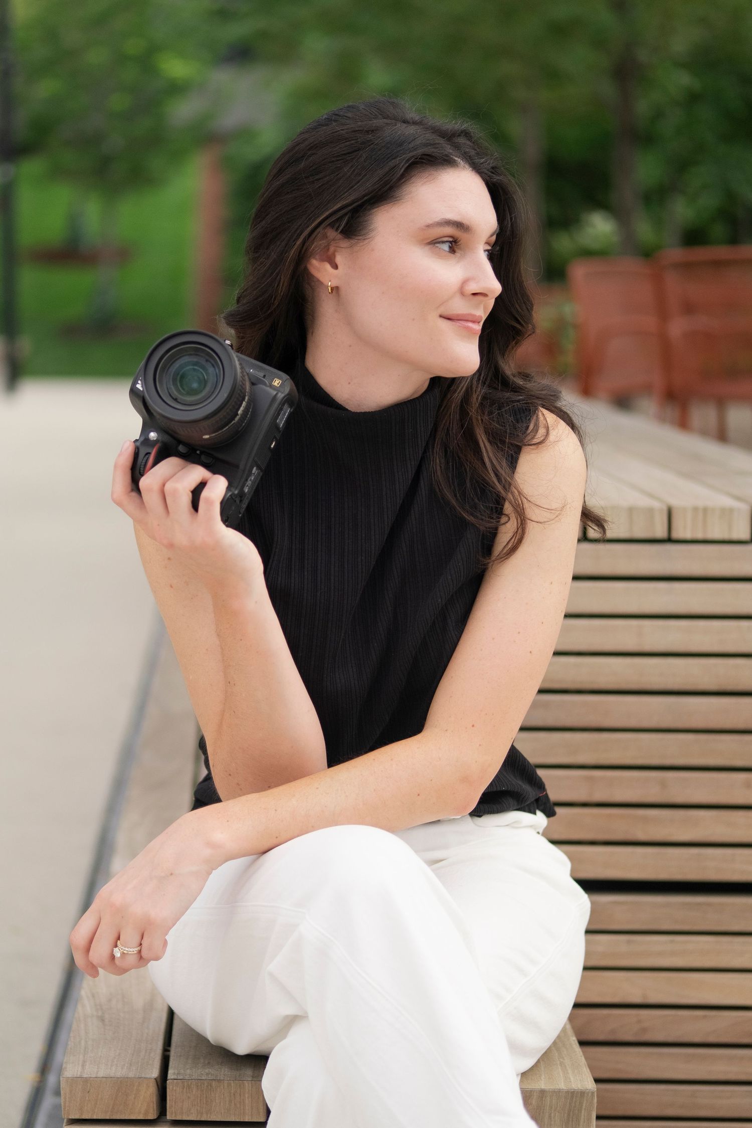 The photographer sitting on a bench during branding photo shoot in downtown Chicago