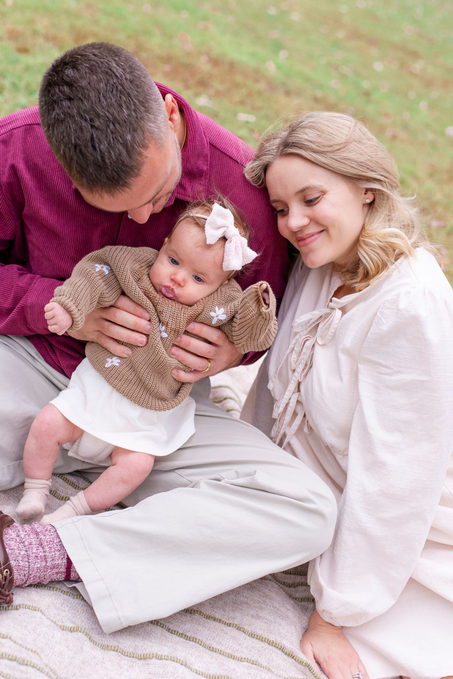 Family holding child during golden hour portrait session in Chicago
