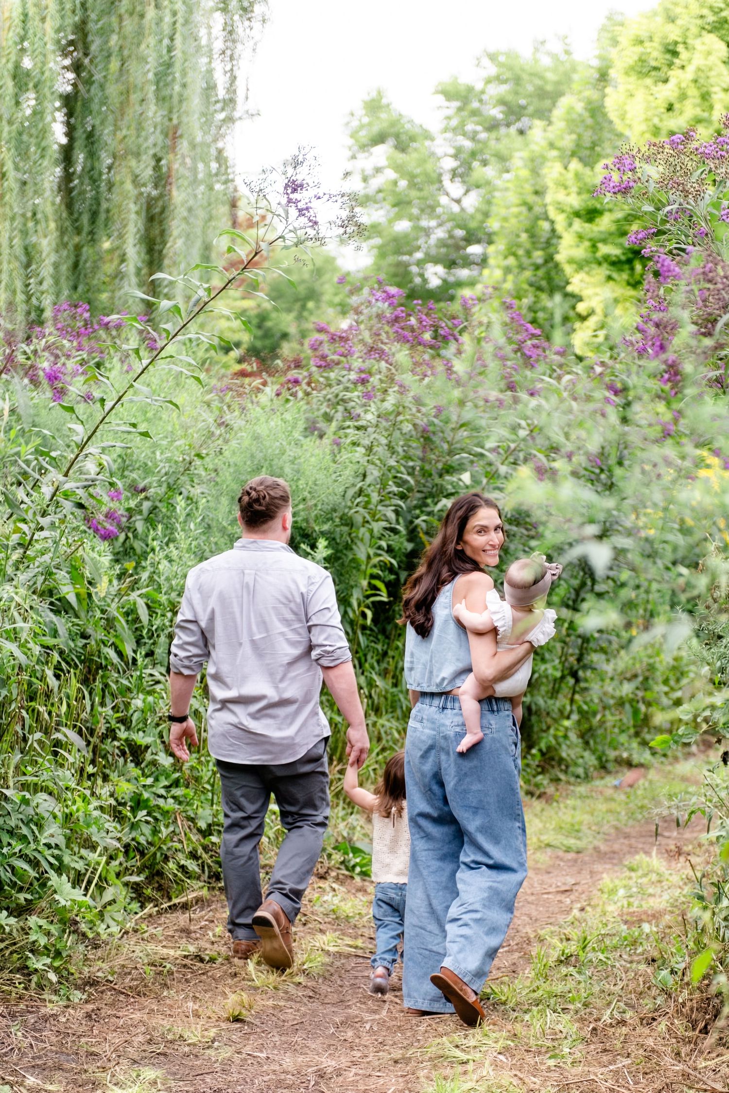 family holding hands in garden during summer portrait session in Chicago