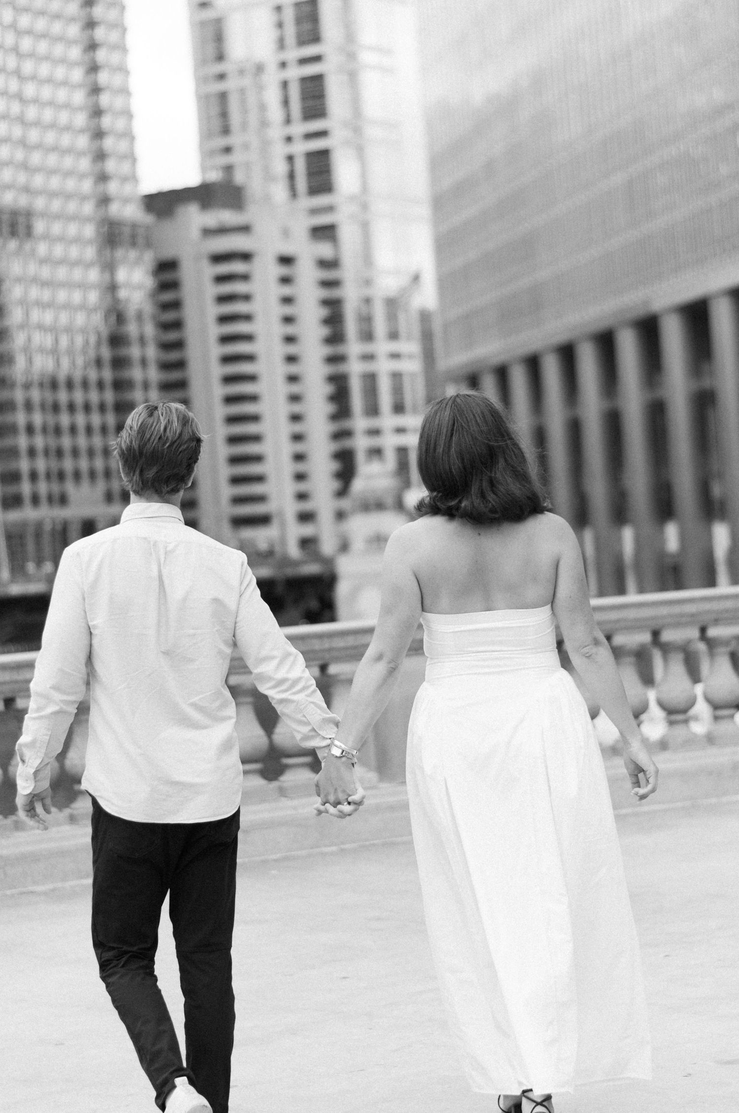 Couple holding hands during romantic portrait session in downtown Chicago