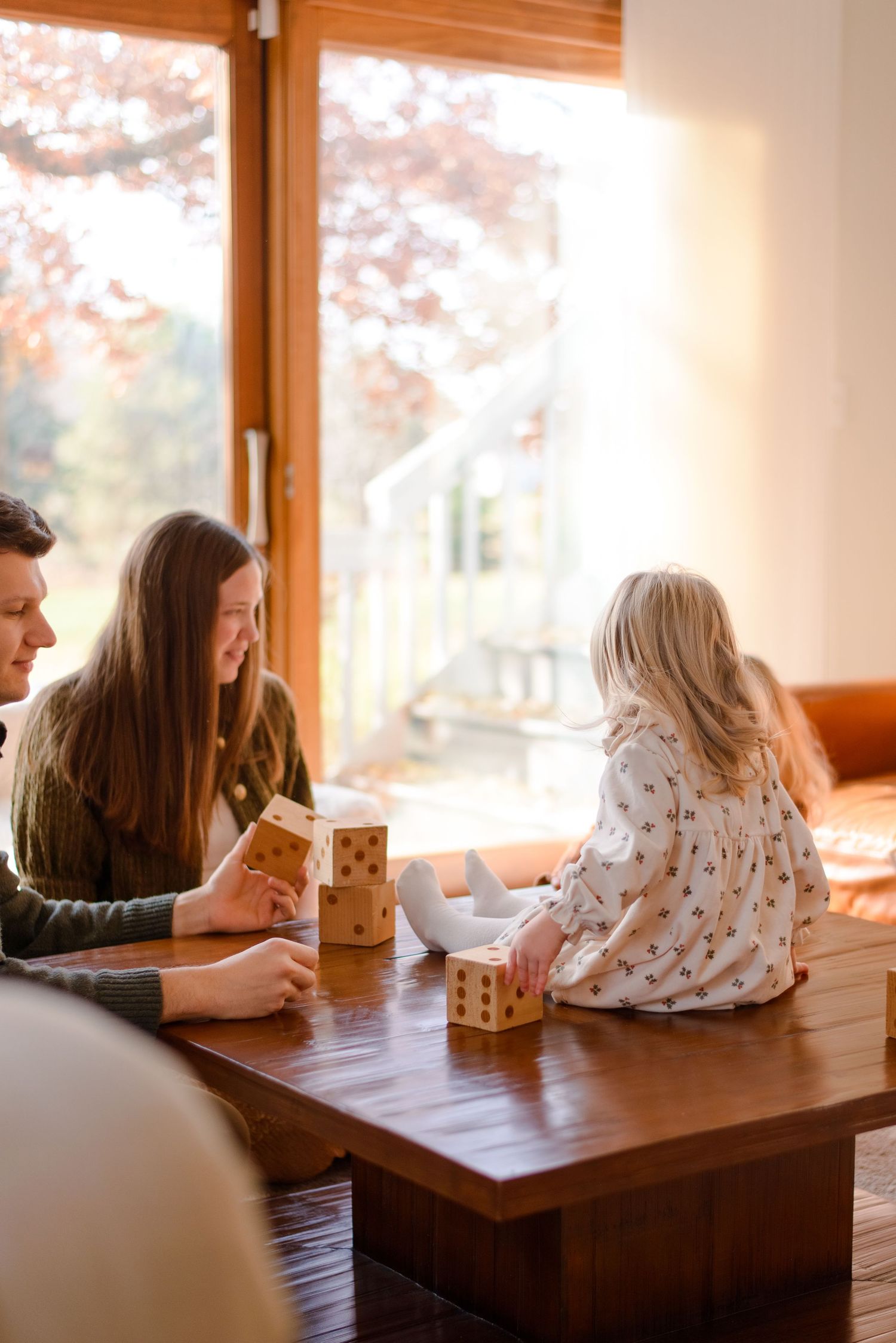 Family playing together indoors during lifestyle sessions in their home