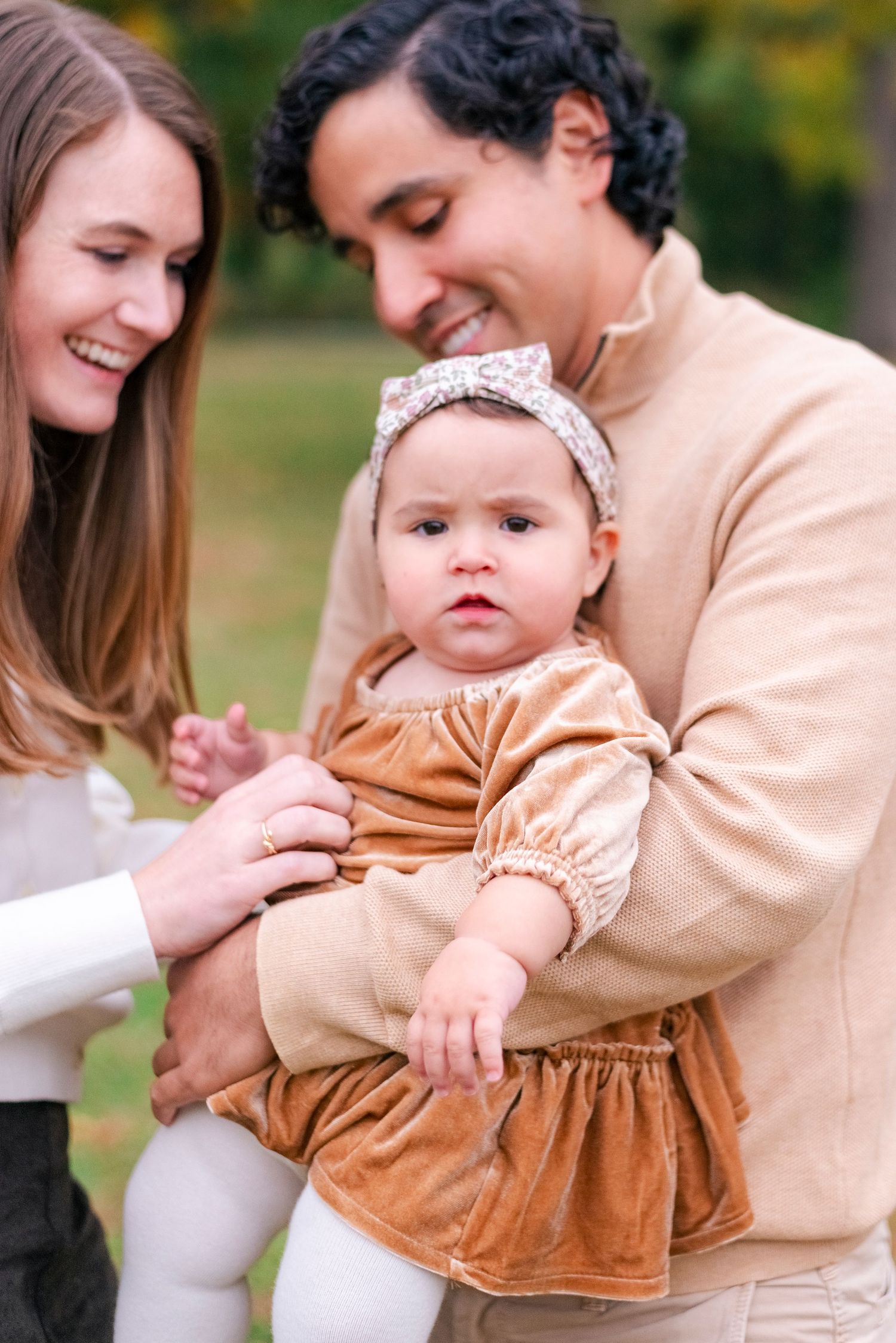 Parents laughing and holding toddler during Chicago suburbs fall photo shoot