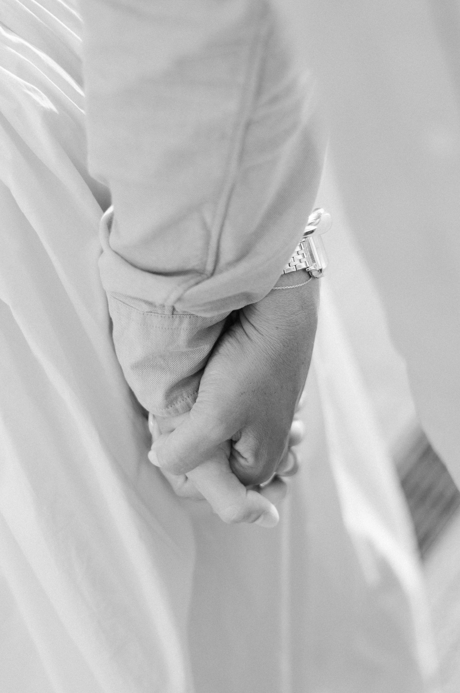 Close up of engaged couple holding hands in city photoshoot