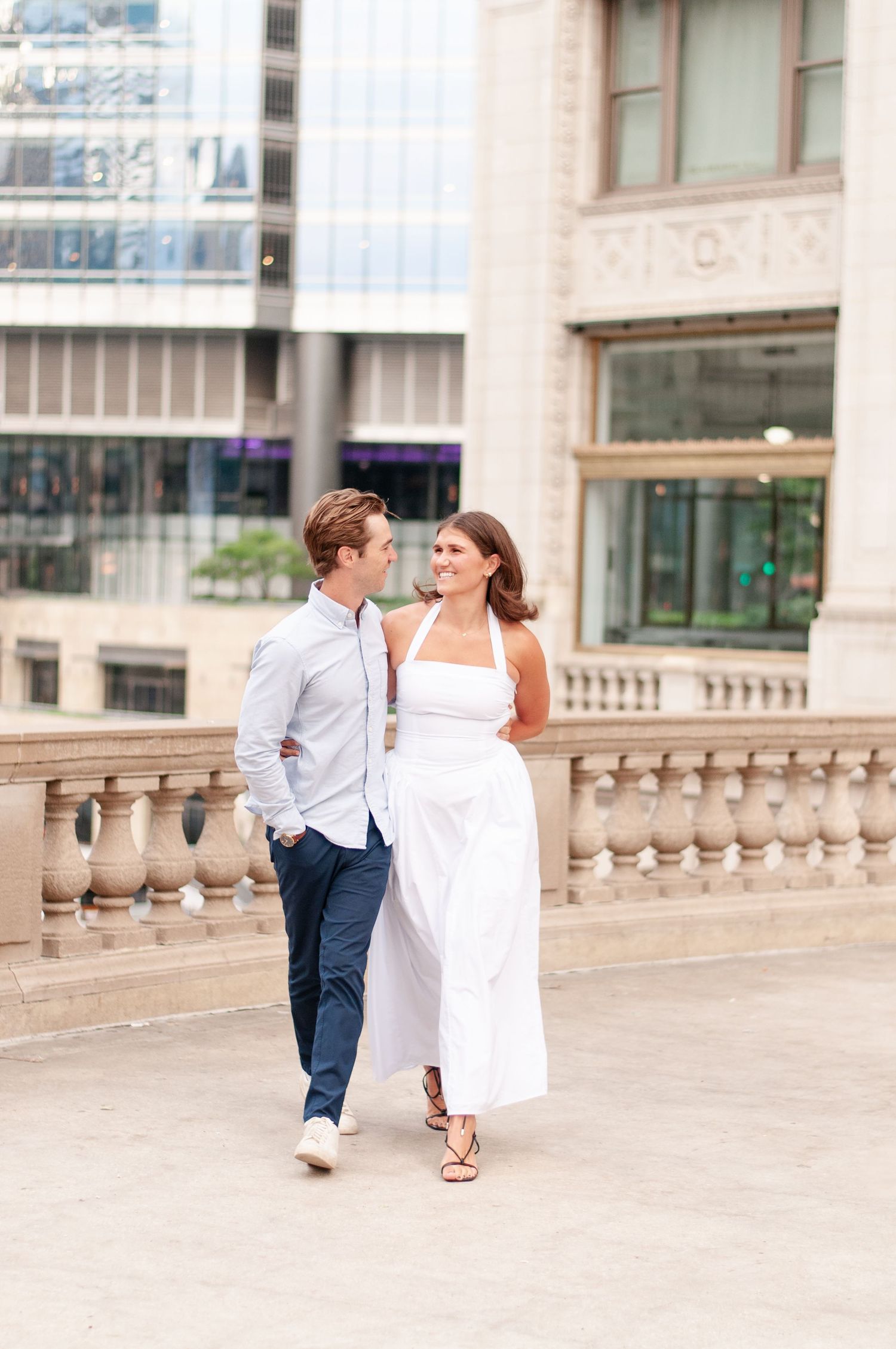 Engaged couple walking together during love story photo session