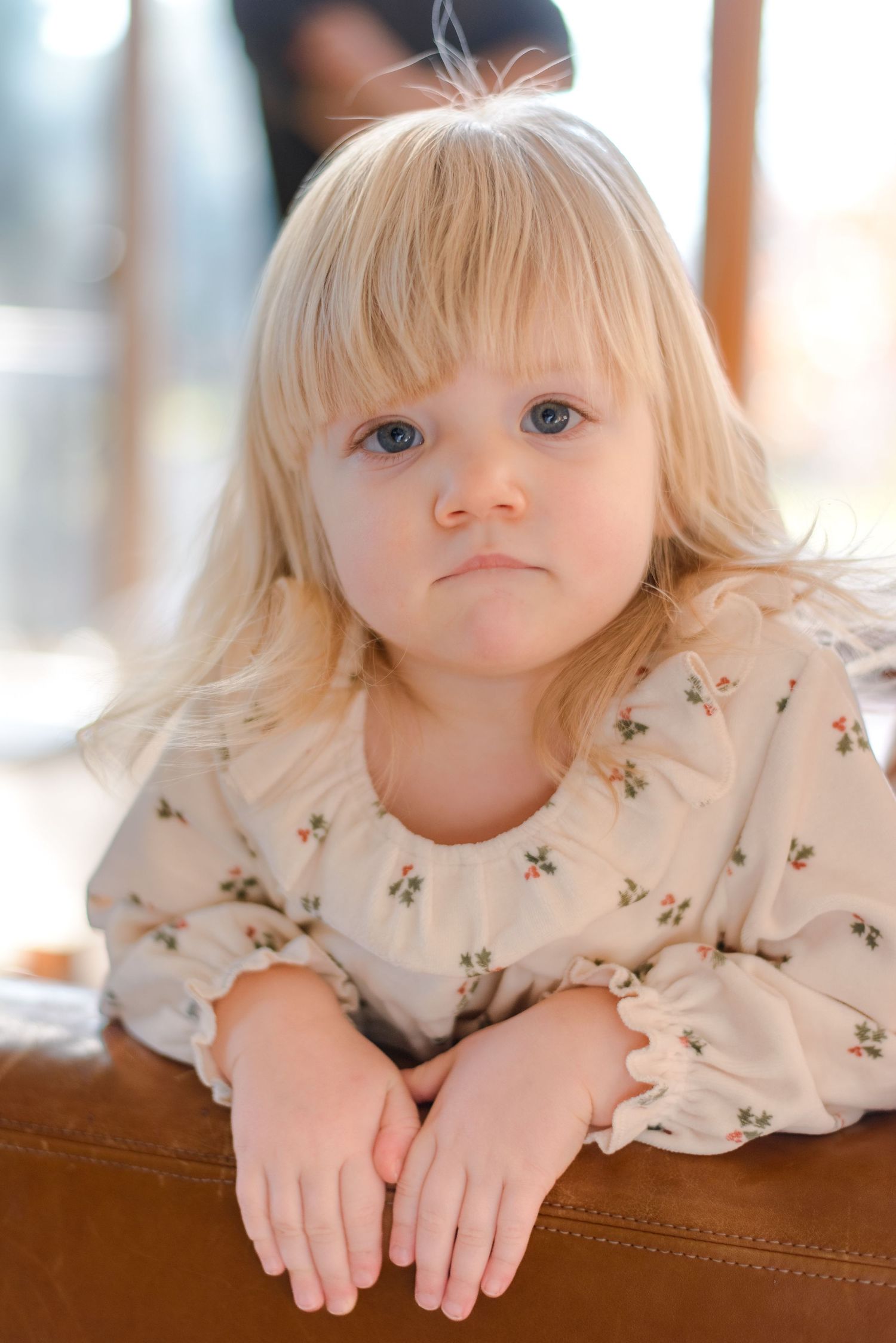 Daughter poses on couch for family photoshoot