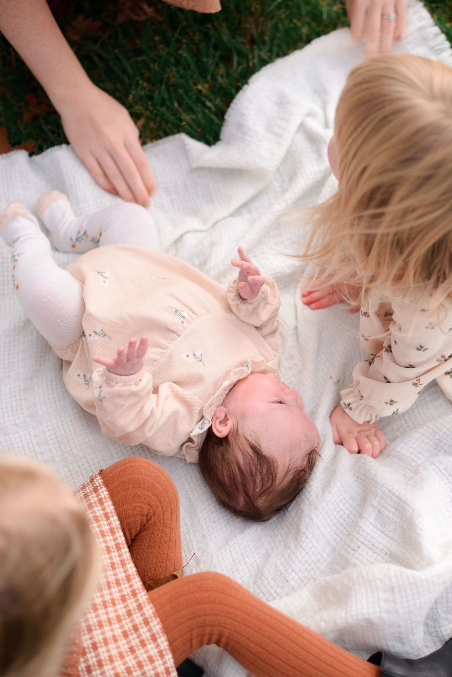 Mother comforting children during outdoor family session