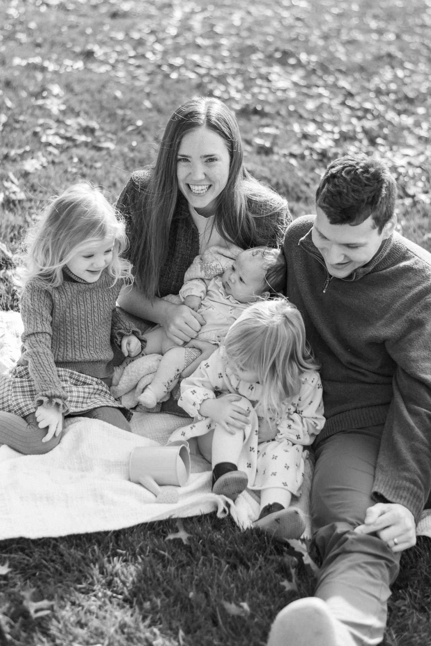 Family smiling for camera during outdoor fall shoot