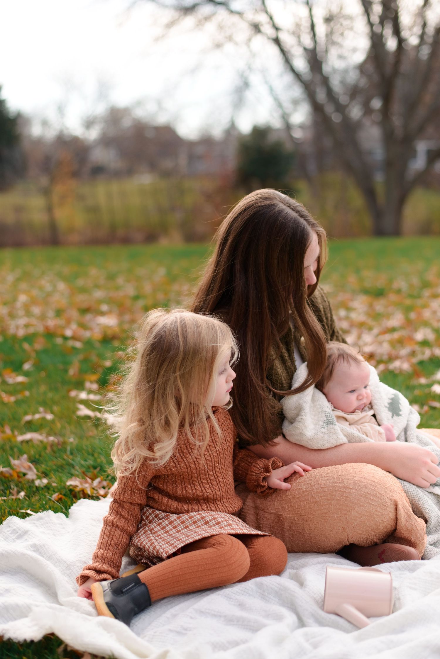 Daughter and mother sharing a quiet moment during cozy fall session