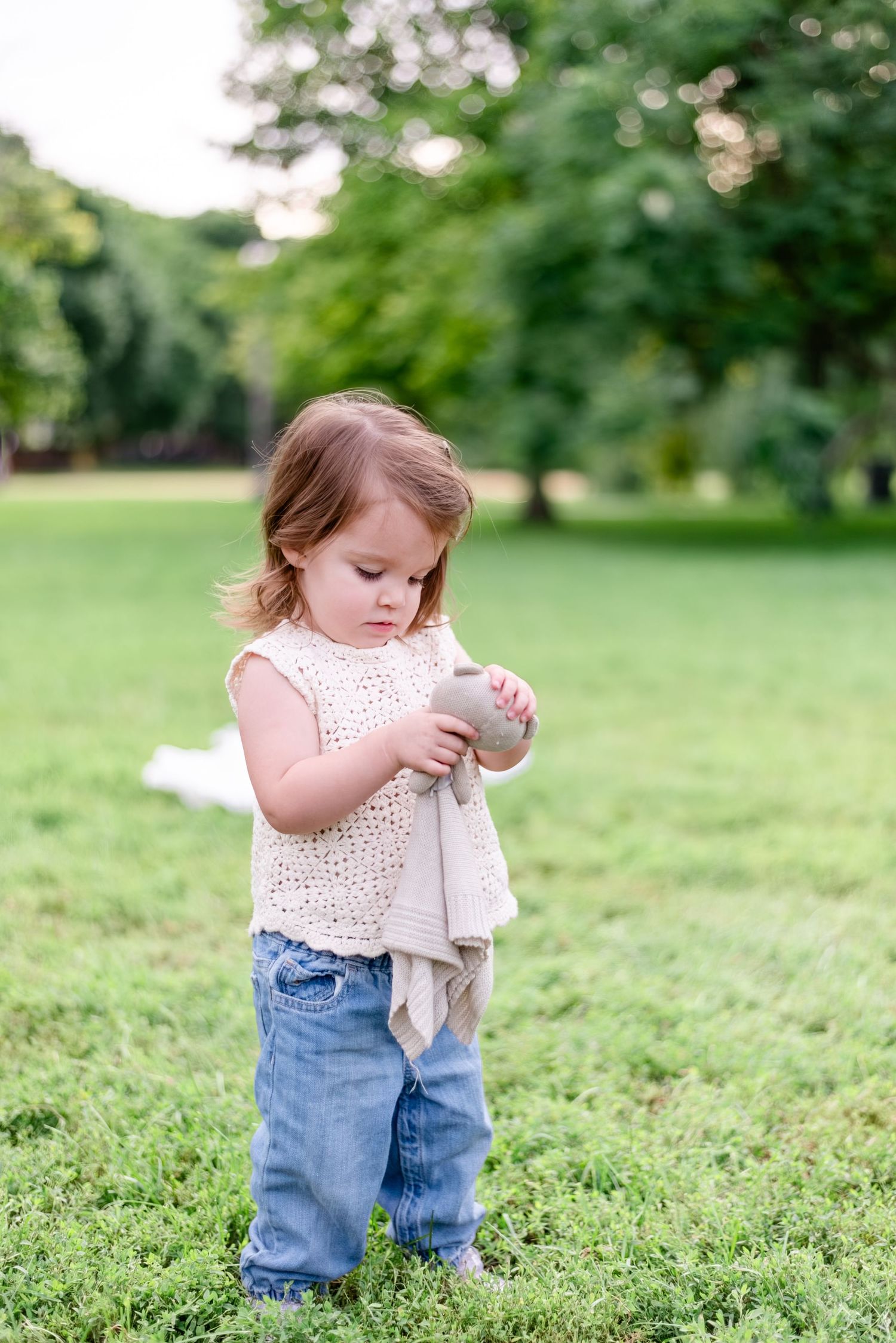 toddler holding stuffed animal during family portrait session