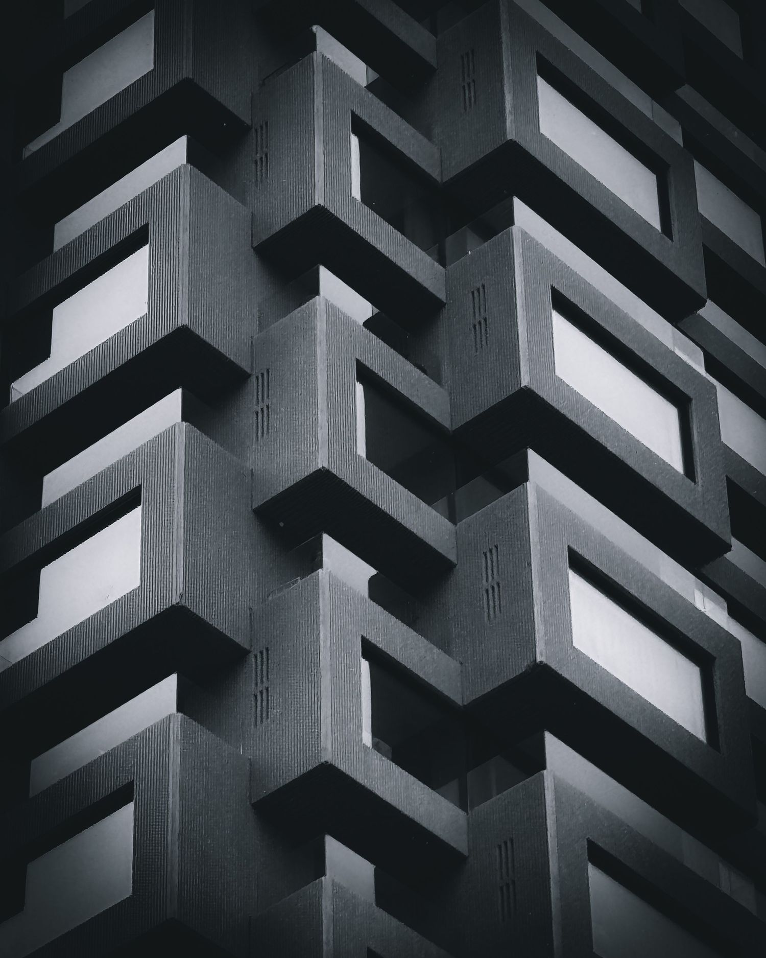 Abstract architectural pattern of black and white geometric shapes forming a repeating angular structure.