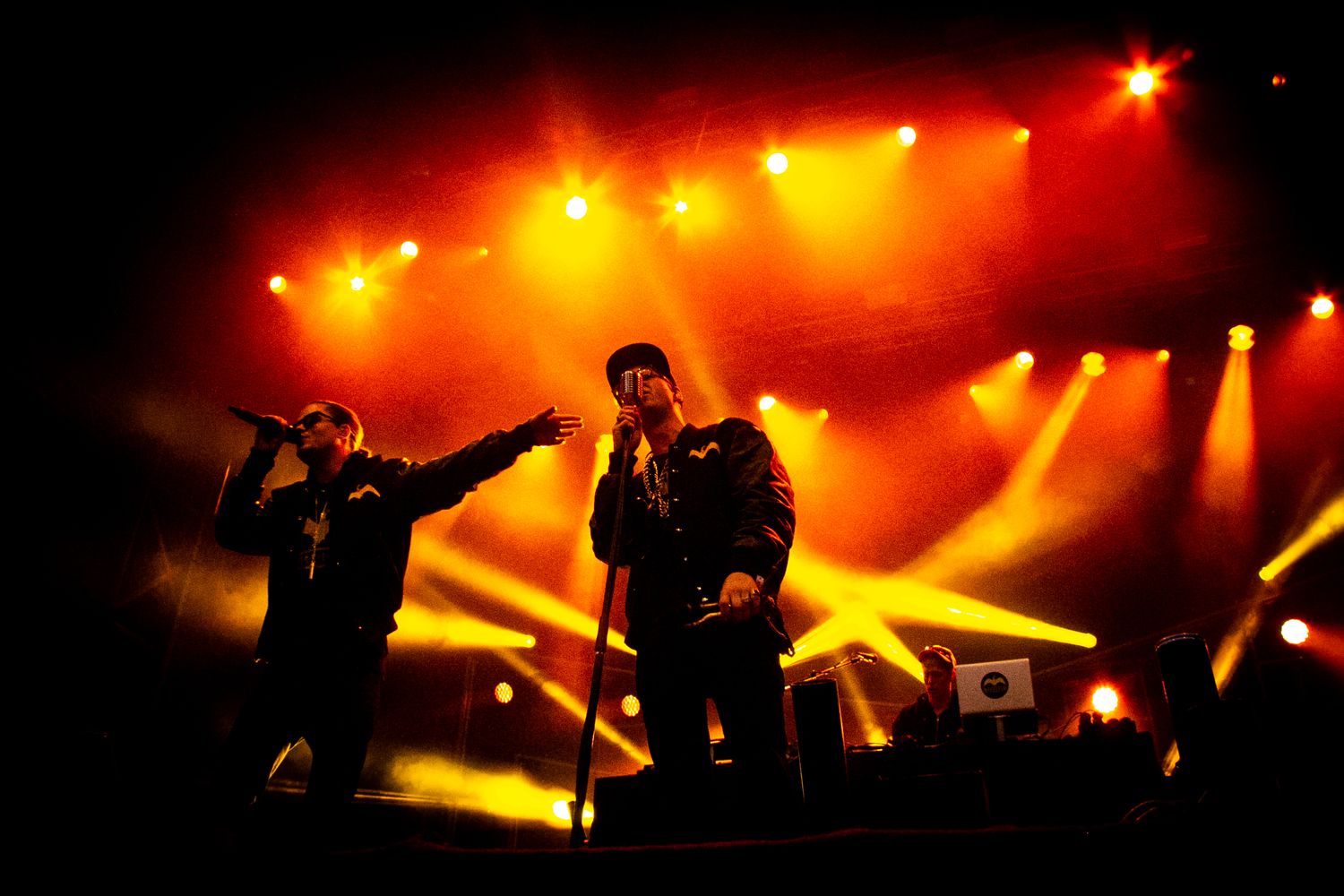 Concert stage illuminated with dramatic orange and red lighting effects during a live performance.