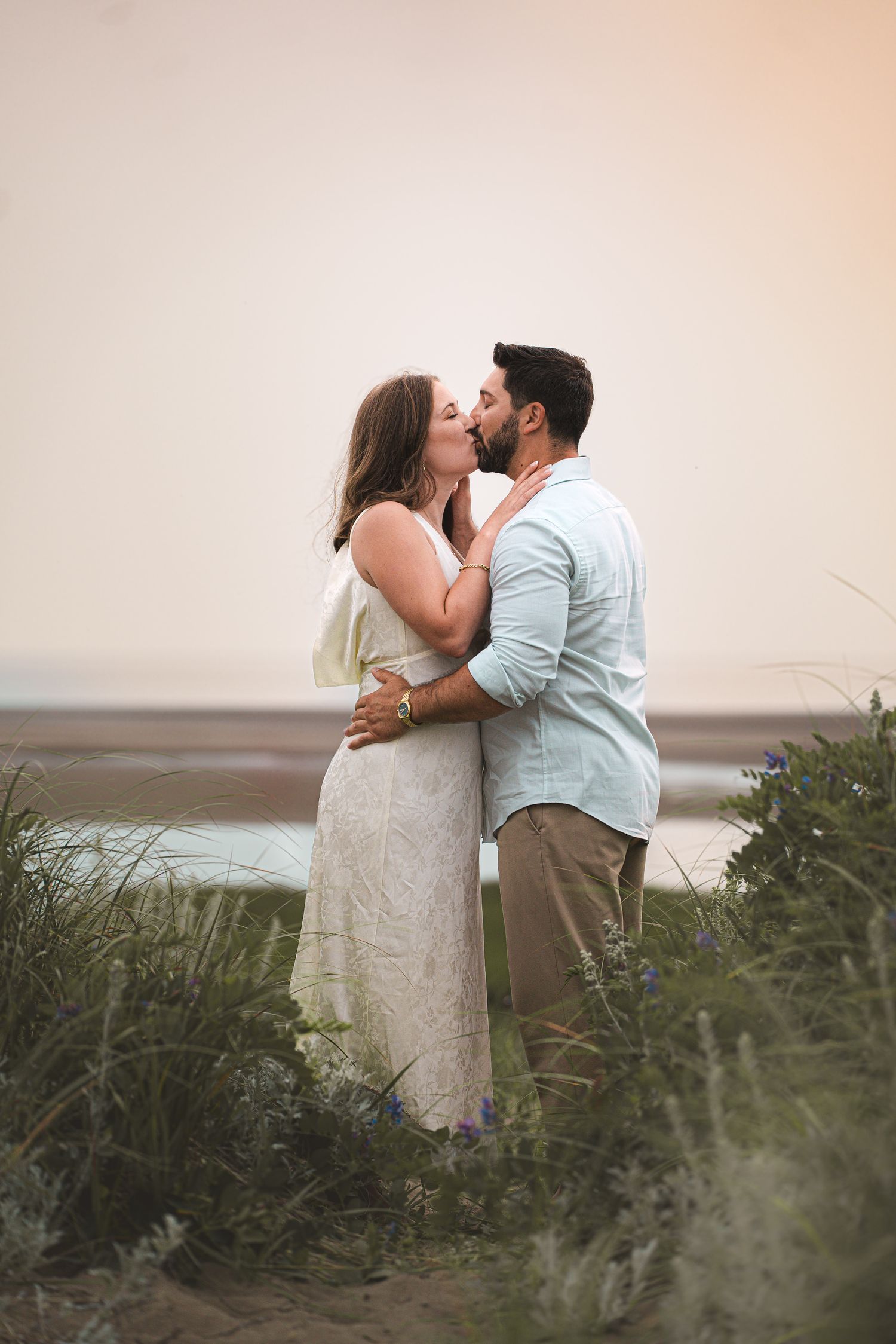 Romantic couple intimate during a golden hour engagement session in beach in Moncton, NB.