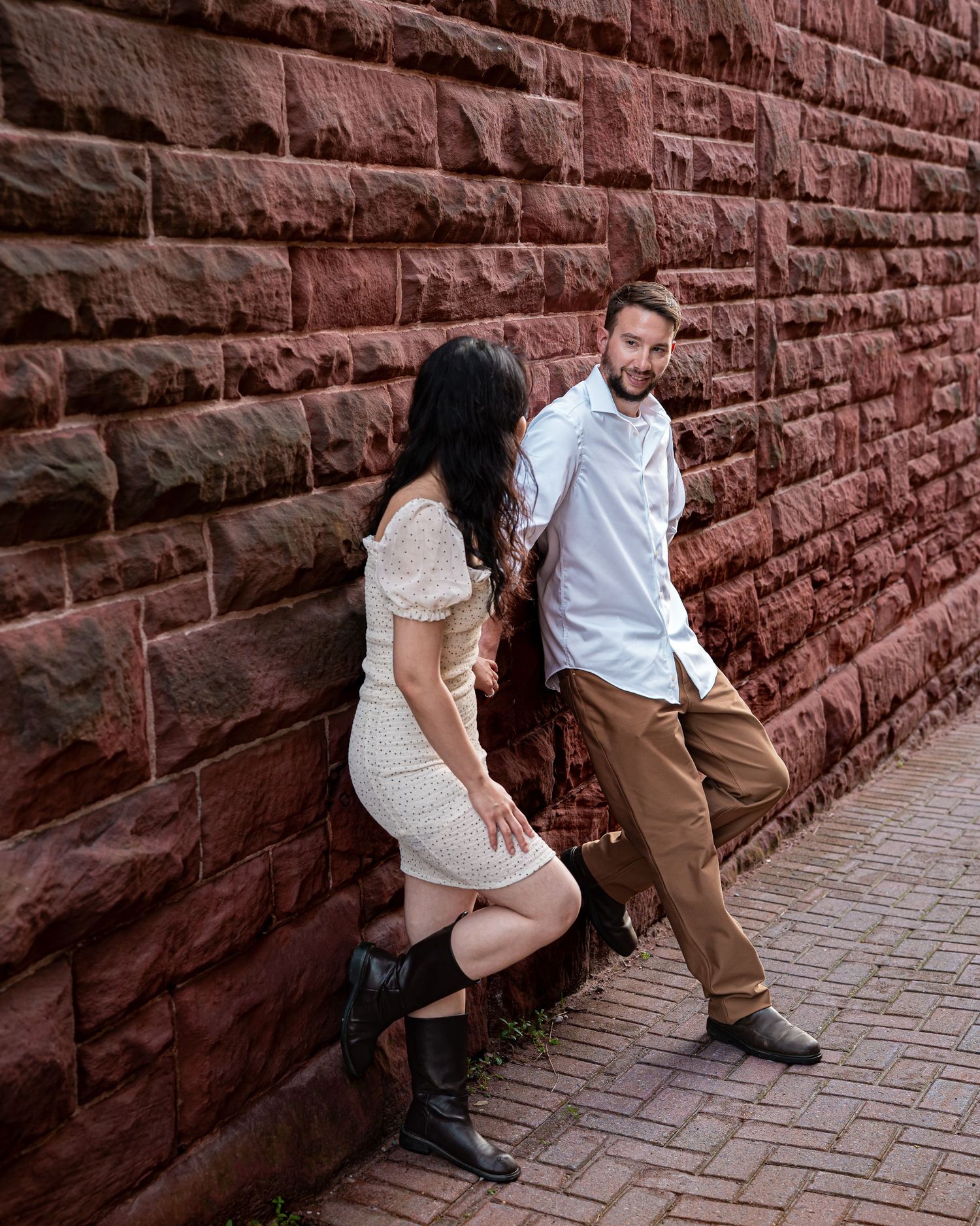 Romantic couple holding hands during a golden hour engagement session in downtown in Moncton, NB. Engagement city shoot