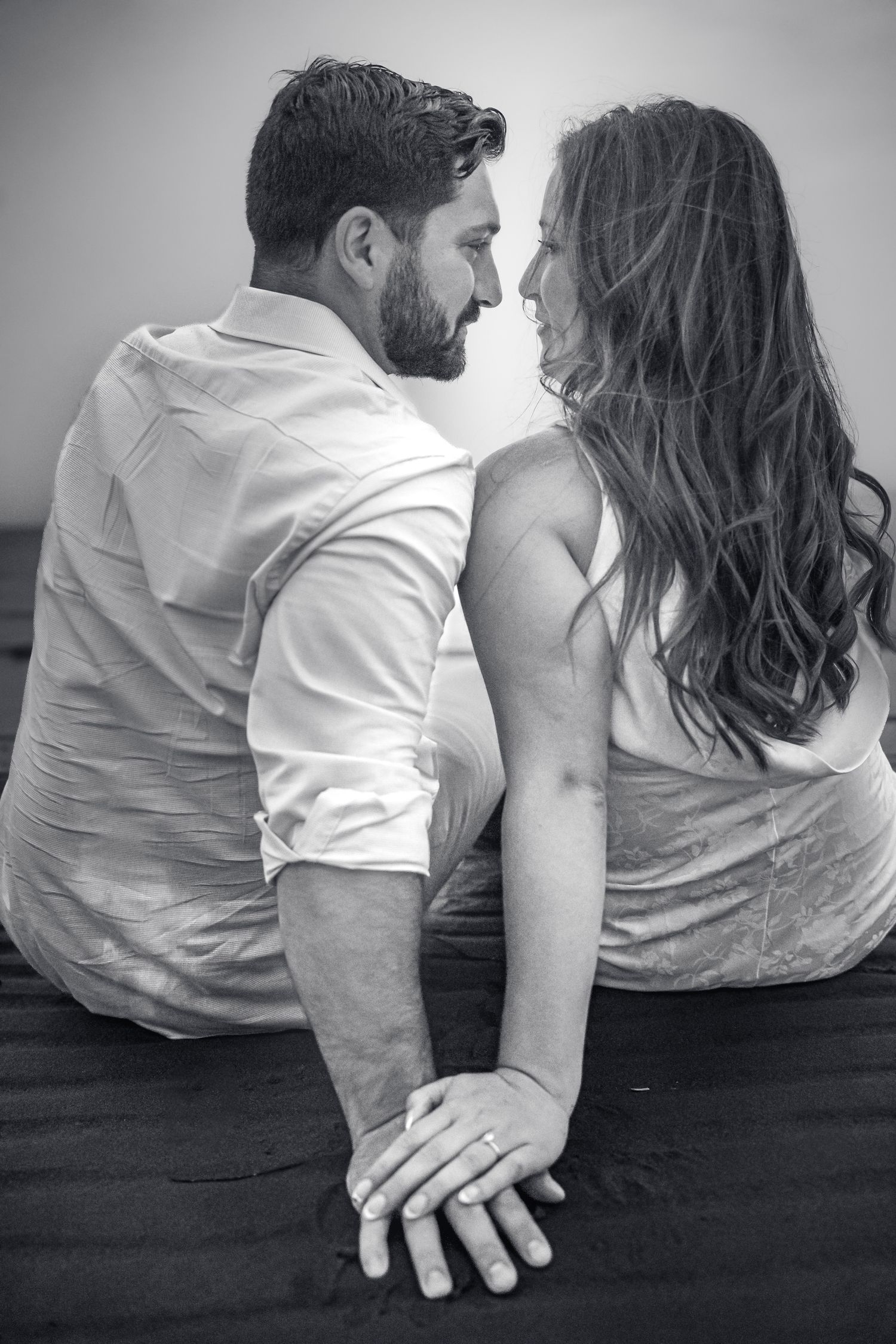 Romantic couple intimate during a golden hour engagement session in beach in Moncton, NB.