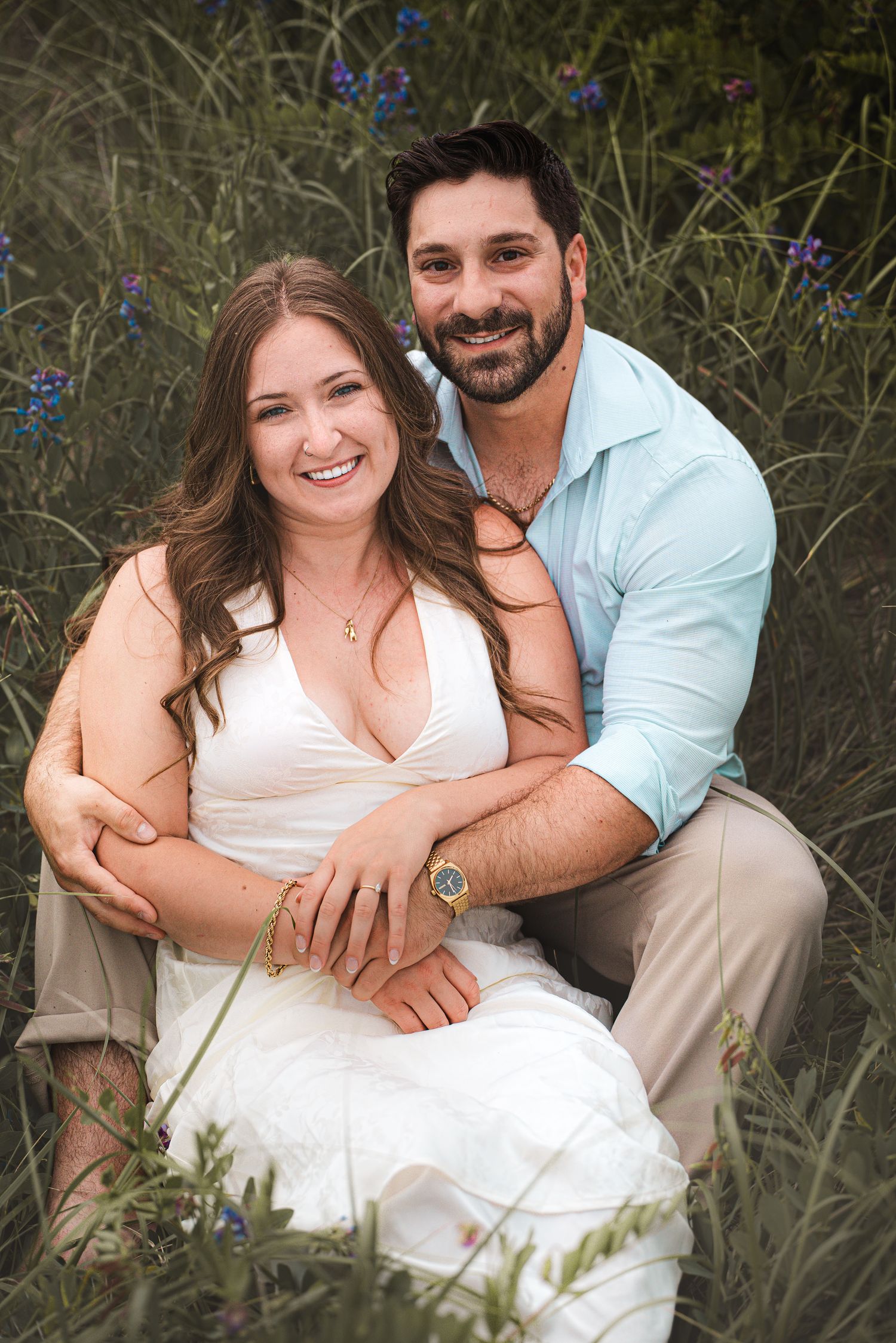 Romantic couple kissing a golden hour engagement session in flower field in Moncton, NB.