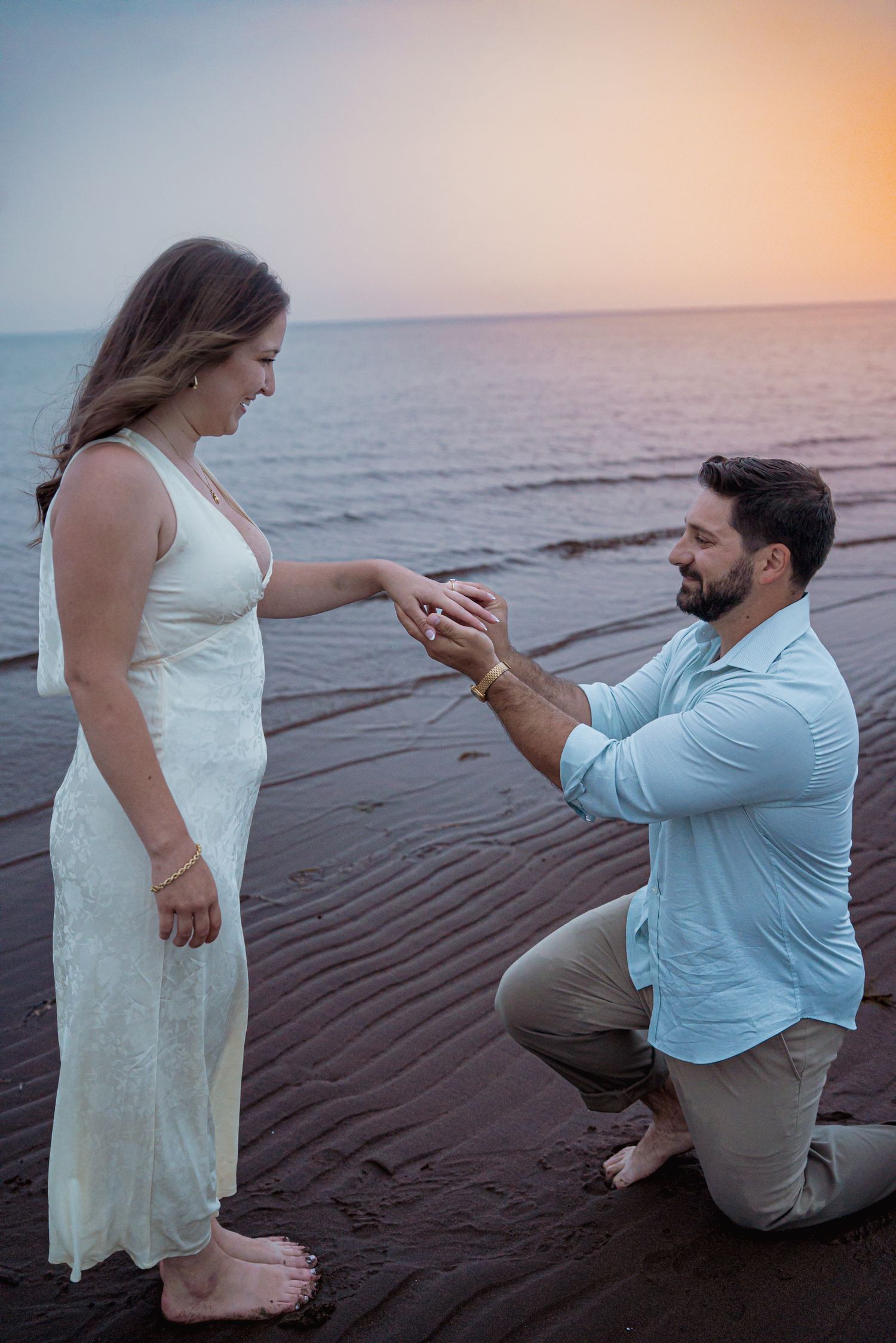 Romantic couple proposal during a golden hour engagement session in beach in Moncton, NB. Engagement beach shoot
