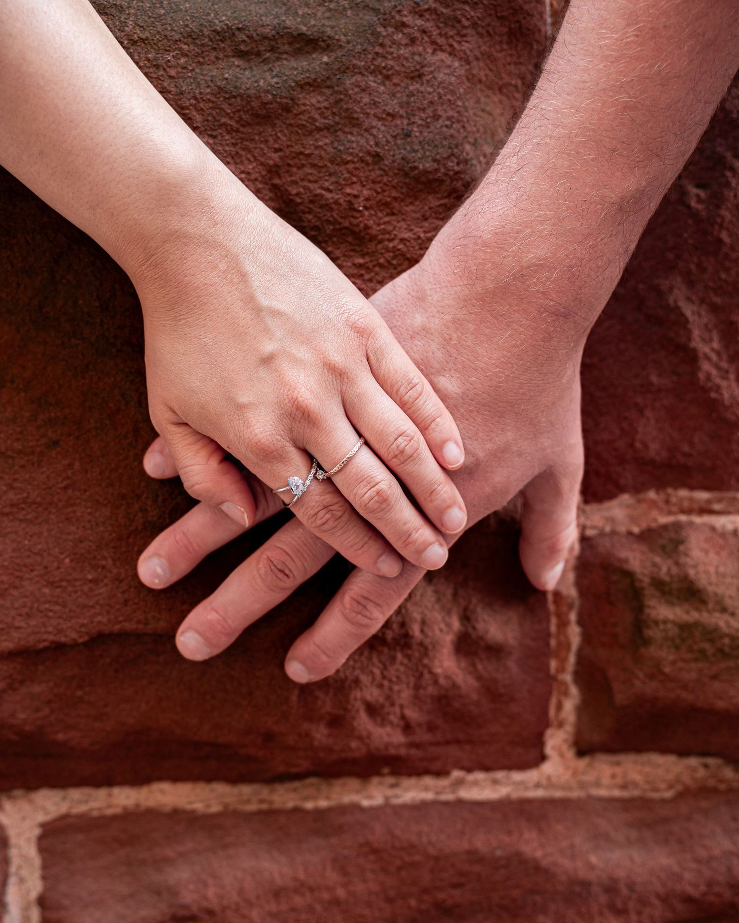 Romantic couple holding hands during a golden hour engagement session in downtown in Moncton, NB. Engagement city shoot
