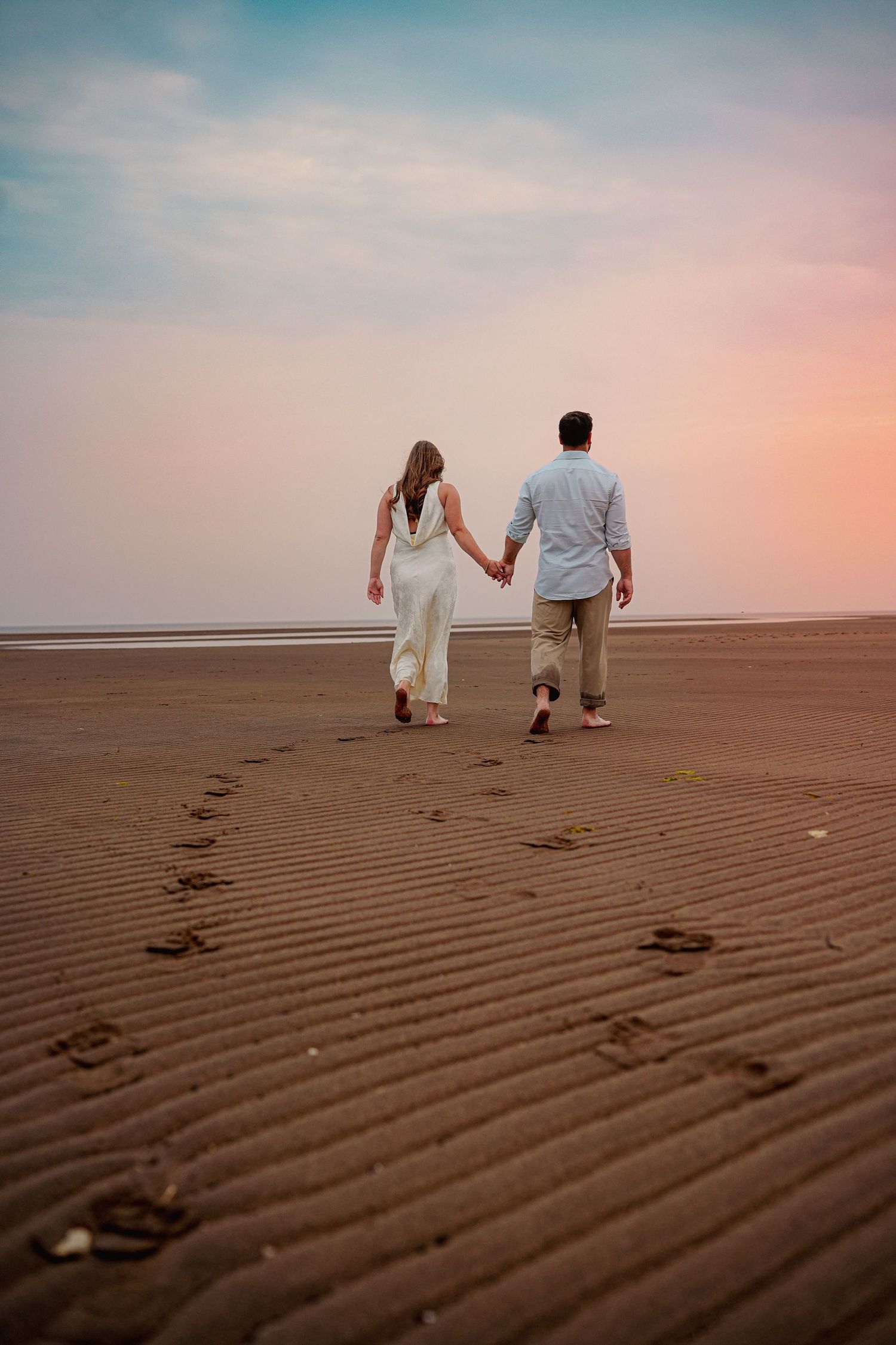 Romantic couple intimate during a golden hour engagement session in beach in Moncton, NB.