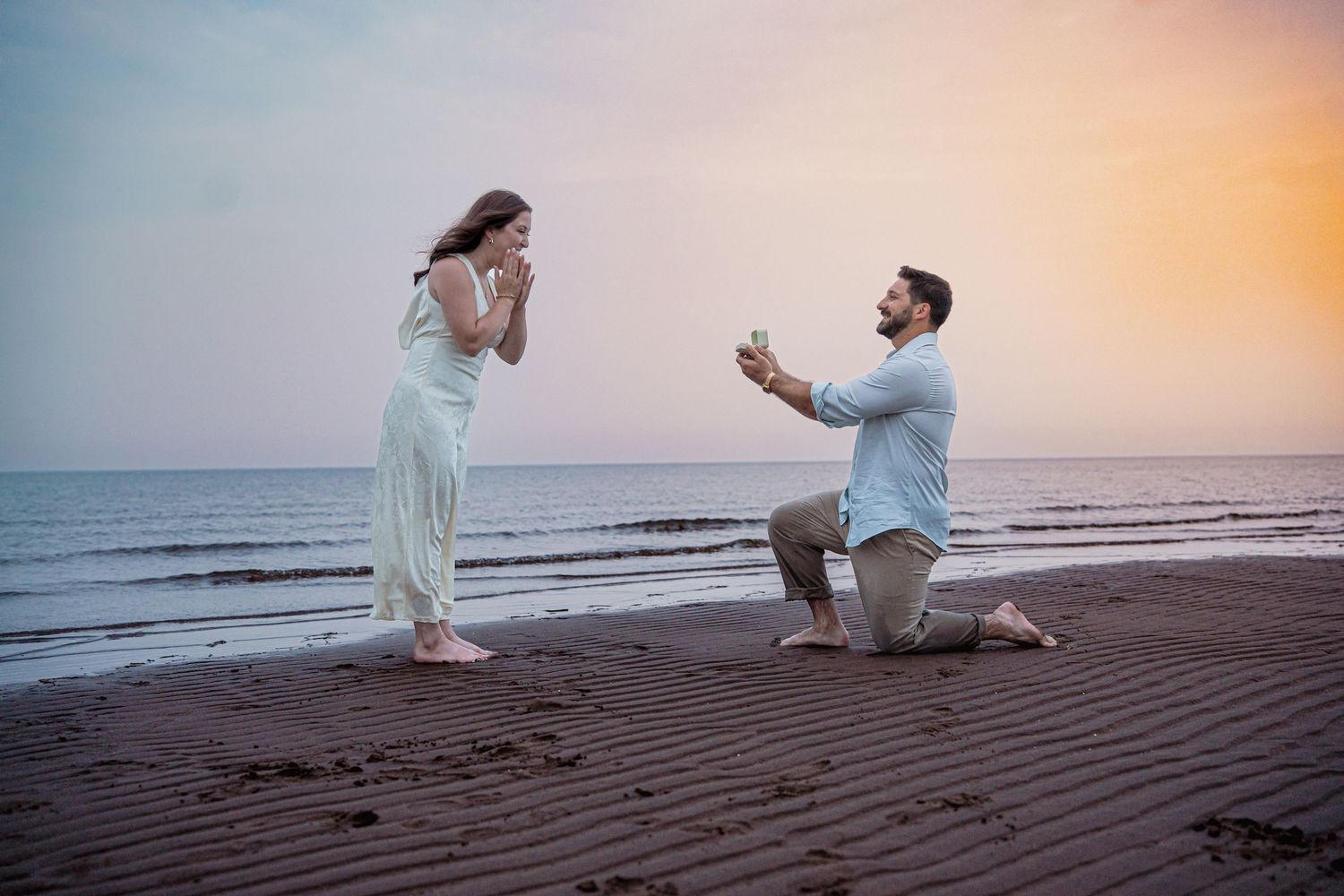 Romantic couple proposal during a golden hour engagement session in beach in Moncton, NB. Engagement beach shoot