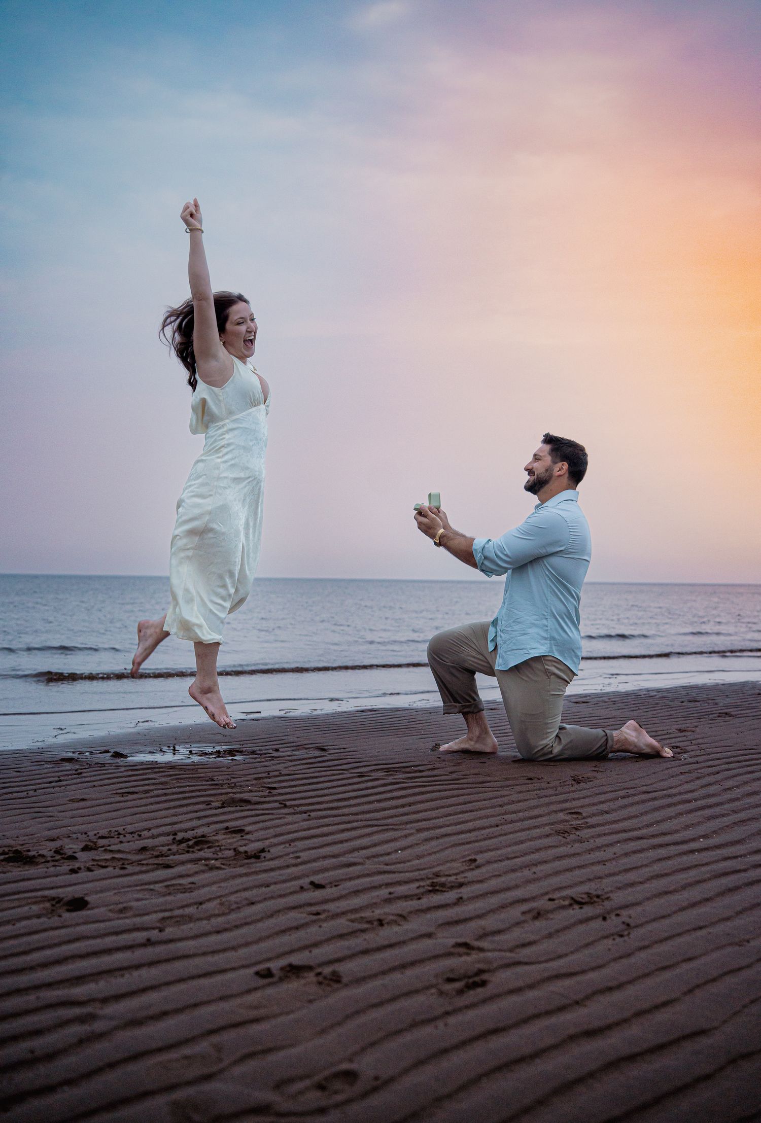 Romantic couple intimate during a golden hour engagement session in beach in Moncton, NB.